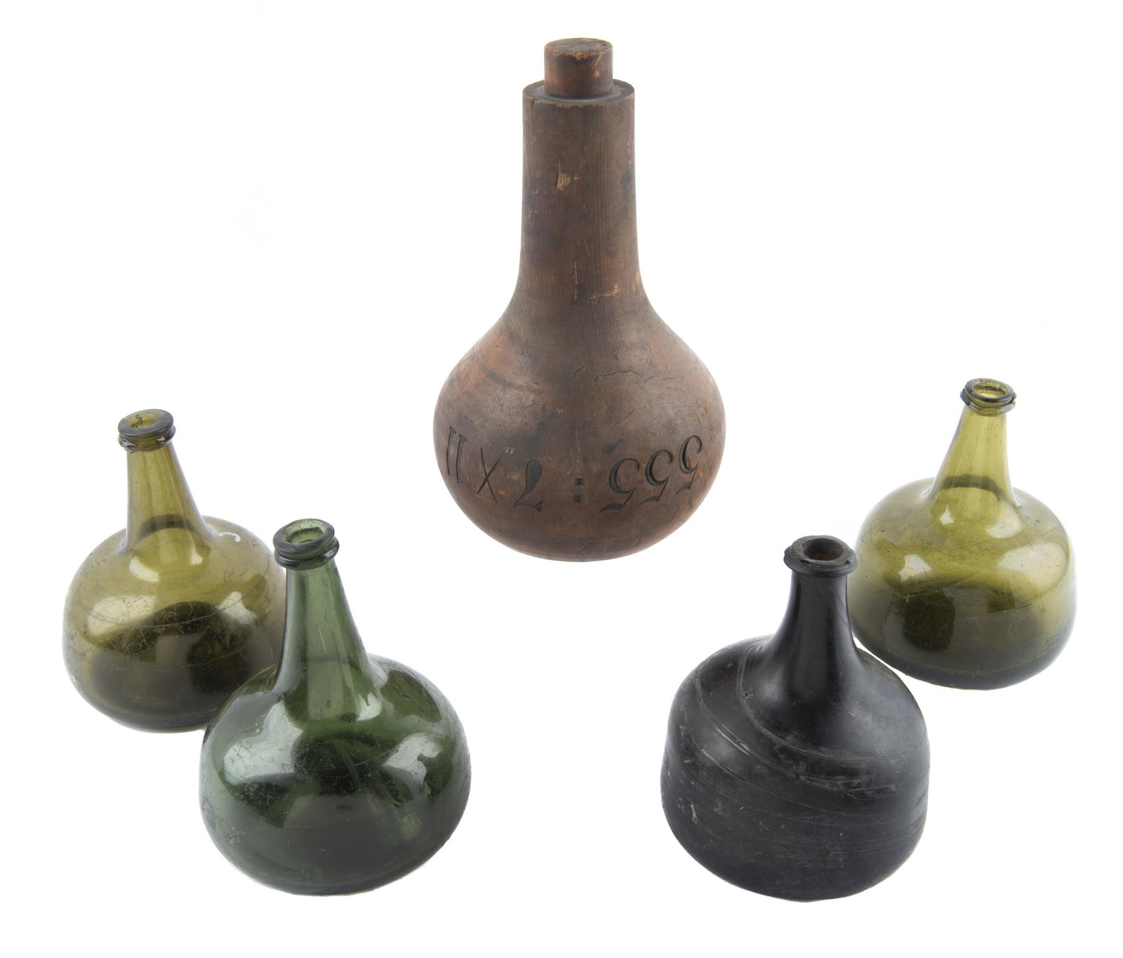 4 Blown Glass Bottles & Bottle Mold: DESCRIPTION: Four blown glass wine or spirits bottles and one wood bottle mold. 19th century. One amber glass and three green. Rough pontils. Mold marked "555:7x11". MEASURMENTS: Glass 6" x 6-3/4". Mo