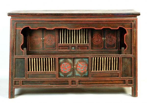 Painted Chinese Low Cabinet: DESCRIPTION: Black ground with polychrome highlights and decoration on a multi-colored stepped cabinet. 19th century. MEASUREMENTS: 56-1/2" wide x 18" deep x 36" high. CONDITION: Wear to surface consi
