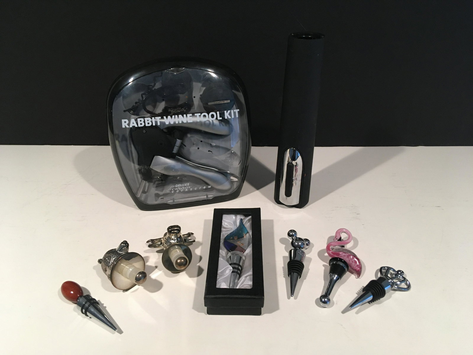 9 Pcs Assorted Wine Accessories: Includes: Rabbit Wine tool kit, electric corkscrew, and seven bottle plugs. From 4 to 10-1/2 high.