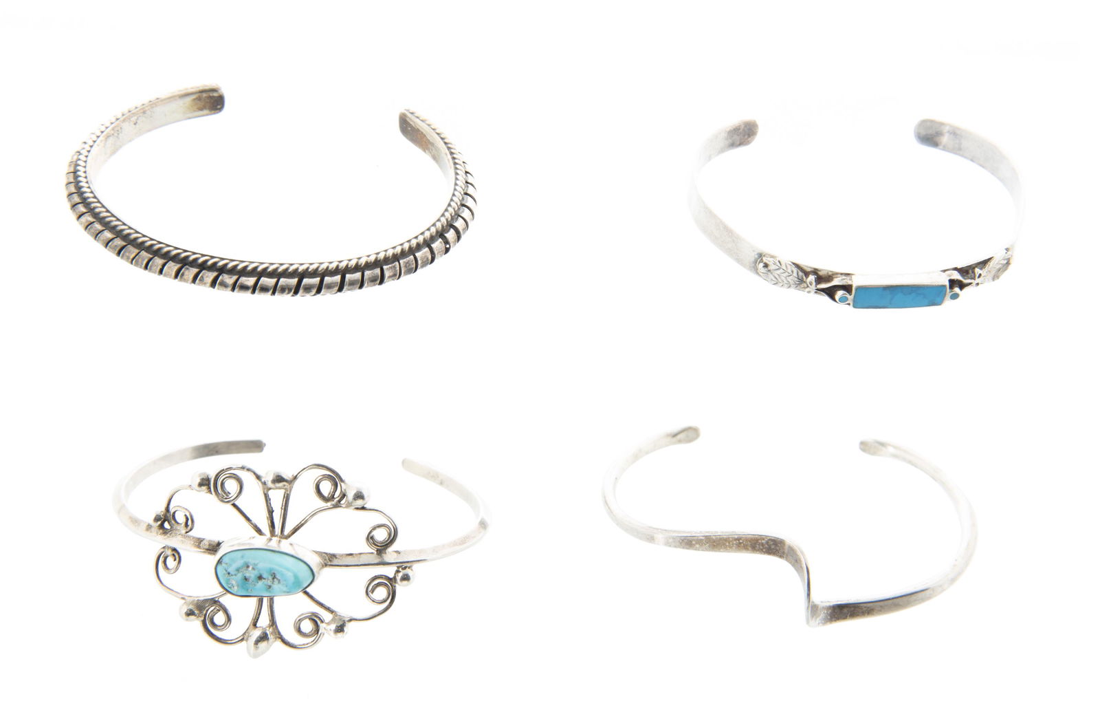 4 Silver Cuff Bracelets: DESCRIPTION: Four cuff bracelets. Largest and inlaid turquoise stamped 925 / sterling. MEASUREMENTS: 1-1/2" x 2" to 2 x 2-1/2".