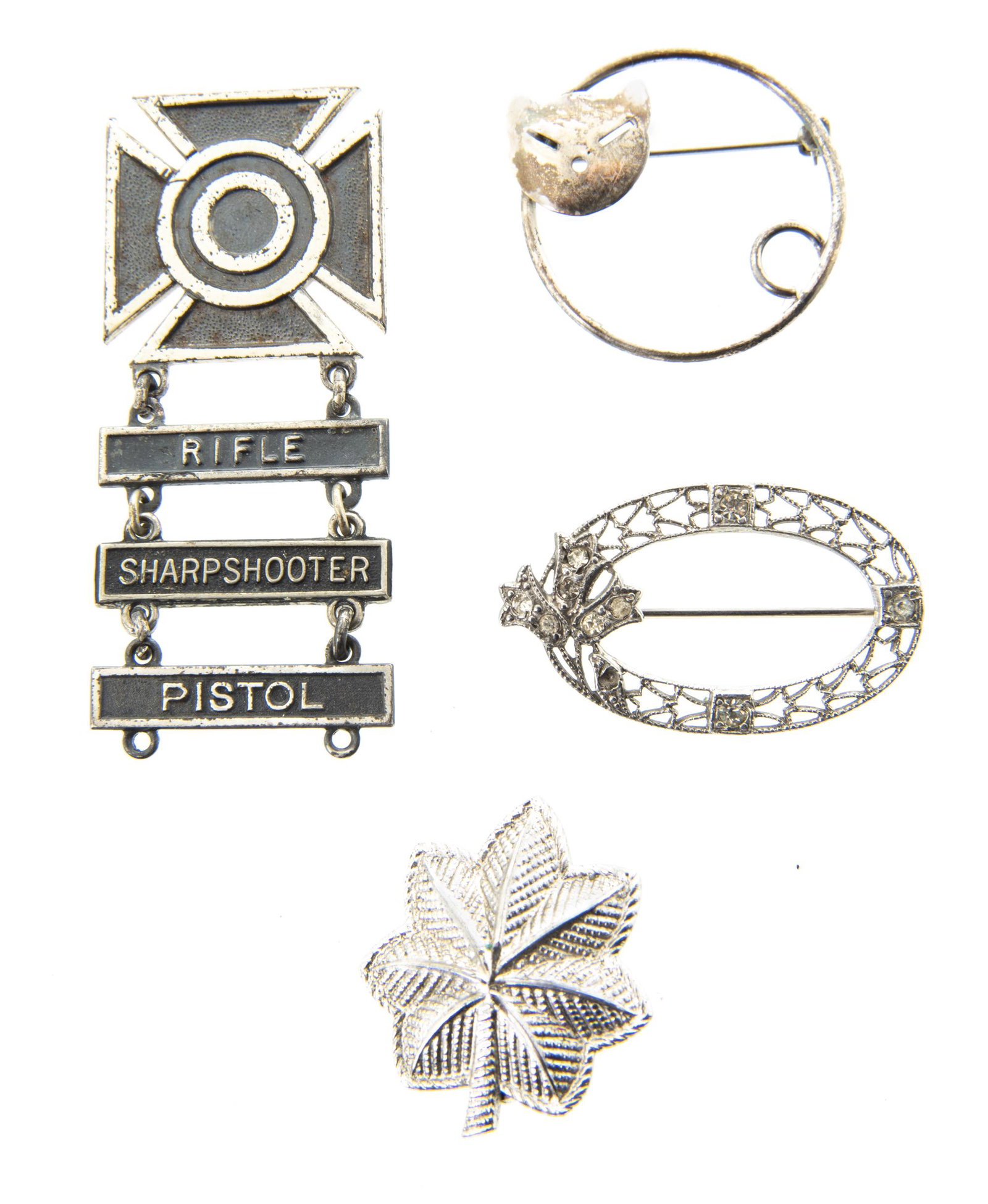 4 Sterling Pins: DESCRIPTION: Four sterling pins including cat, rhinestone, and Rifle Sharpshooter. MEASUREMENTS: 1-1/8" to 2-3/8".