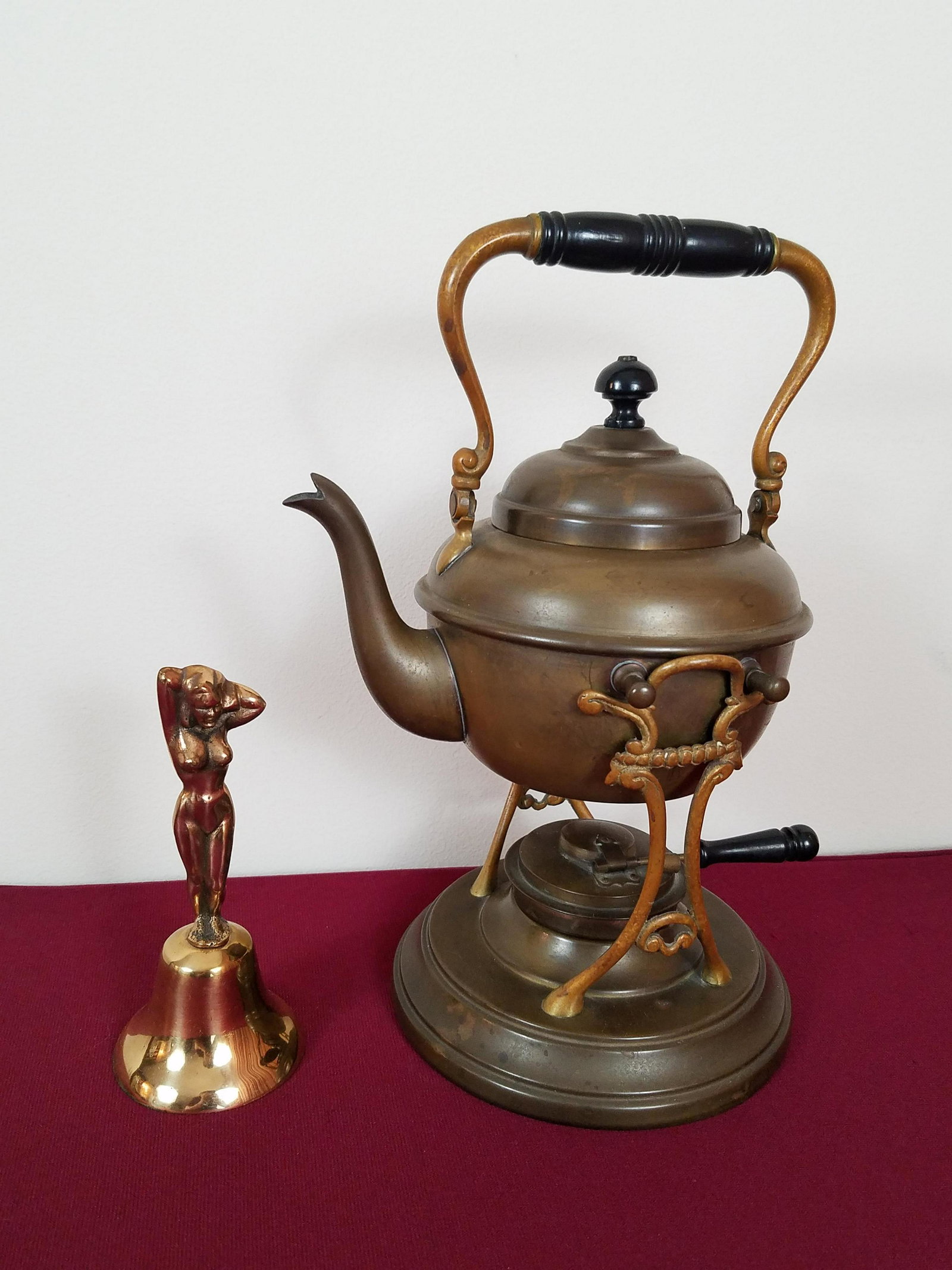 Brass Tea Pot and Nude Bell: Nude bell unmarked. 6" high. Tea pot manufactured by Manning Bowman Quality. Meriden, Conn. 11-1/2" high.