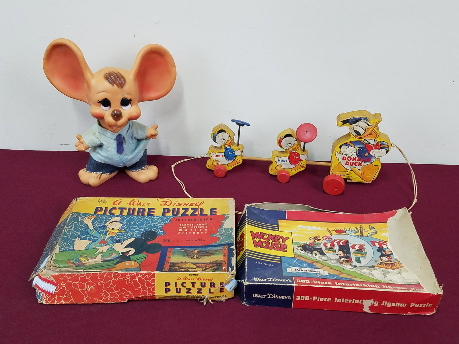 2 Disney Puzzles, Donald Pull Toy and Huron Mouse: 5-3/4" to 10" high. Donald pull toy with broken front wheels. Puzzles with torn boxes.