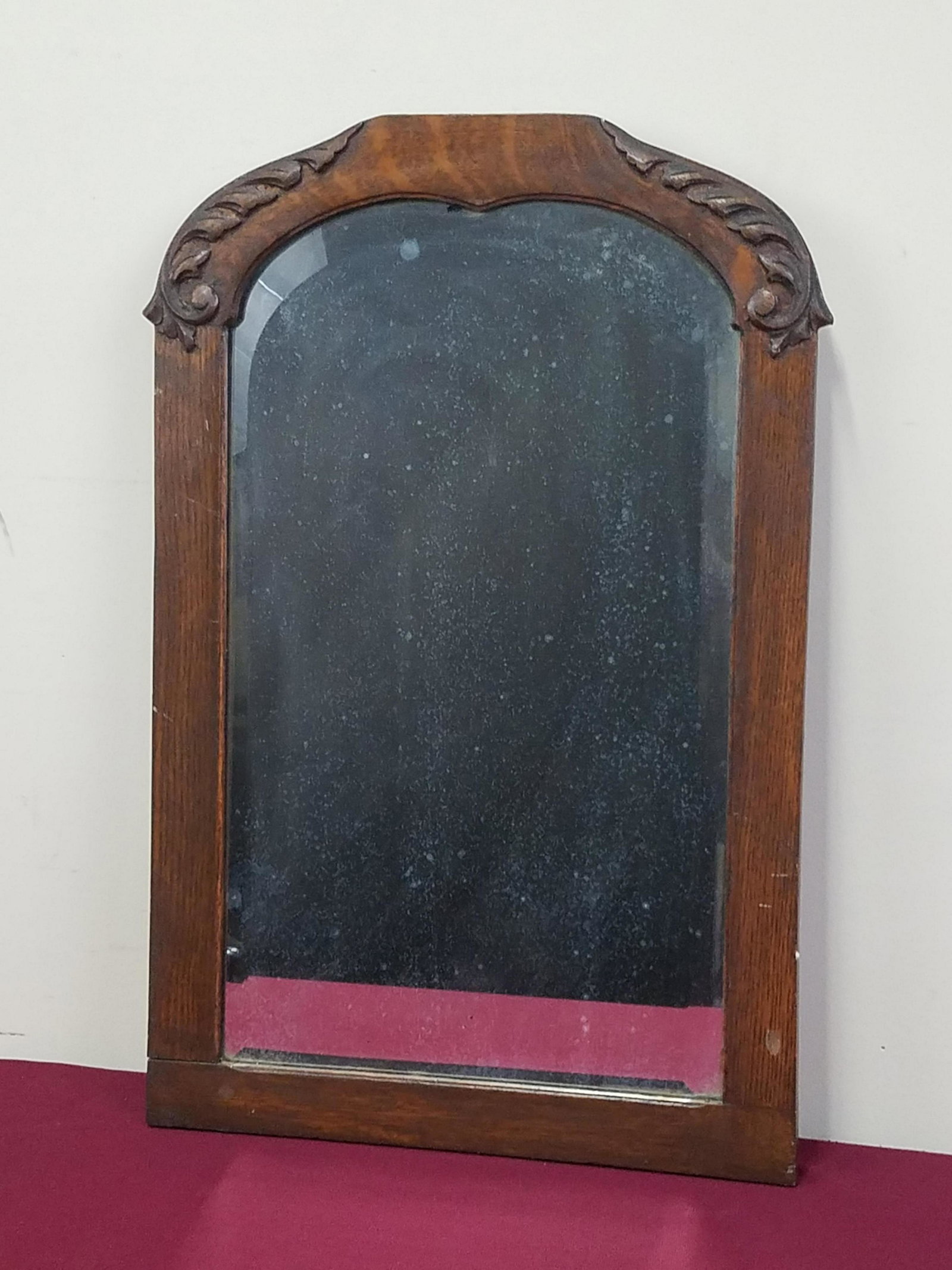 Antique Beveled Glass Mirror: Overall with frame 15" high x 22-1/2" wide. Some spotting in glass.