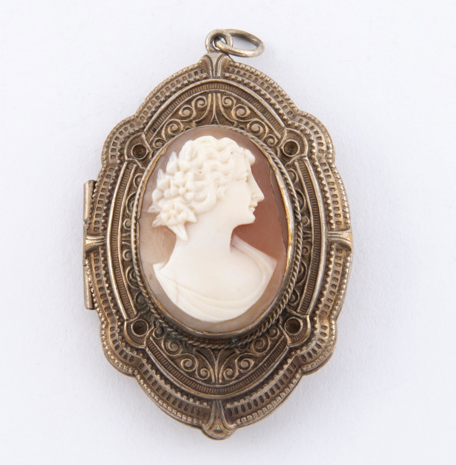 Antique Locket: DESCRIPTION: Antique locket. Shell cameo gilding to interior. Nicely worked case. Probably vermeil. MEASUREMENTS: 1-7/8" x 1-1/4".