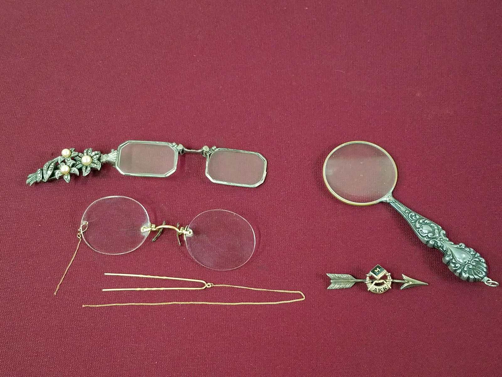 4 Pcs Vintage Glasses, Magnifying Glass and Pin: Includes sterling and marcasite folding glasses. Unmarked. Also includes "M AKK" arrow pin, unmarked magnifying glass and "Suctions" glasses with broken chain.