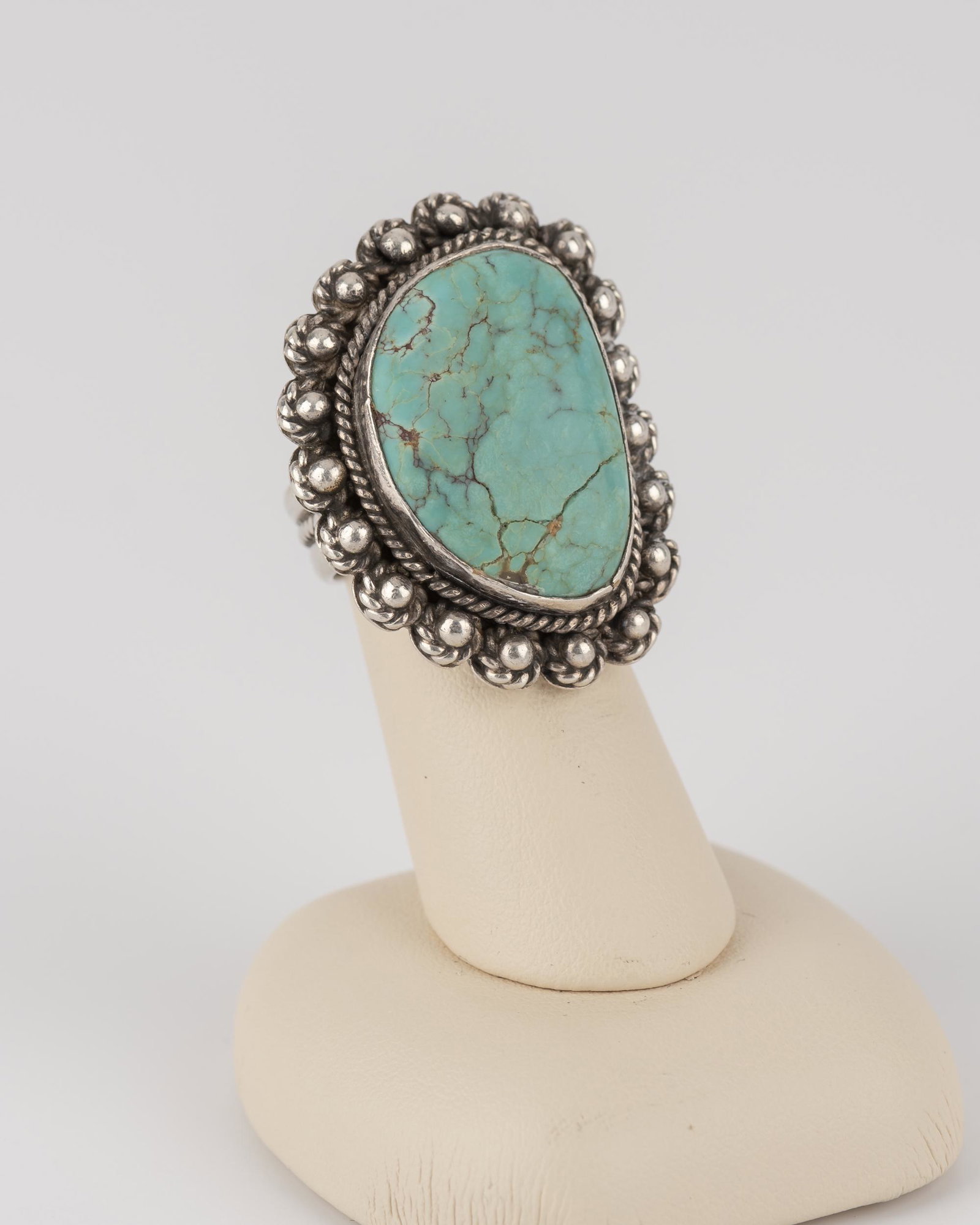Silver And Turquoise Ring: With "Sterling" and possible Floyd Namingha Lomakuyvaya mark. Ring size 7.5. Top 1-3/8".