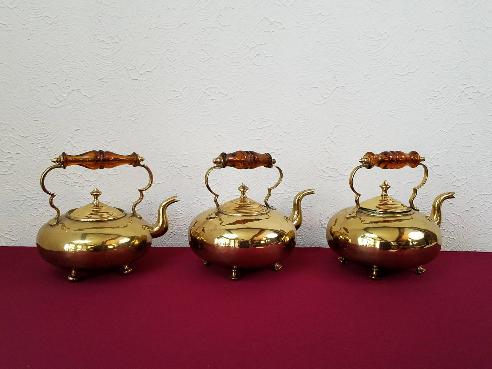 3 Glass Handled Brass Tea Kettles: Stamped "JC. B. Best Hammered Birmingham Make" Each 9-1/4" to 10" wide x 8-1/4" high. Each with chipped handles. IMPORTANT: Before bidding, please read the terms and conditions below. When you registe