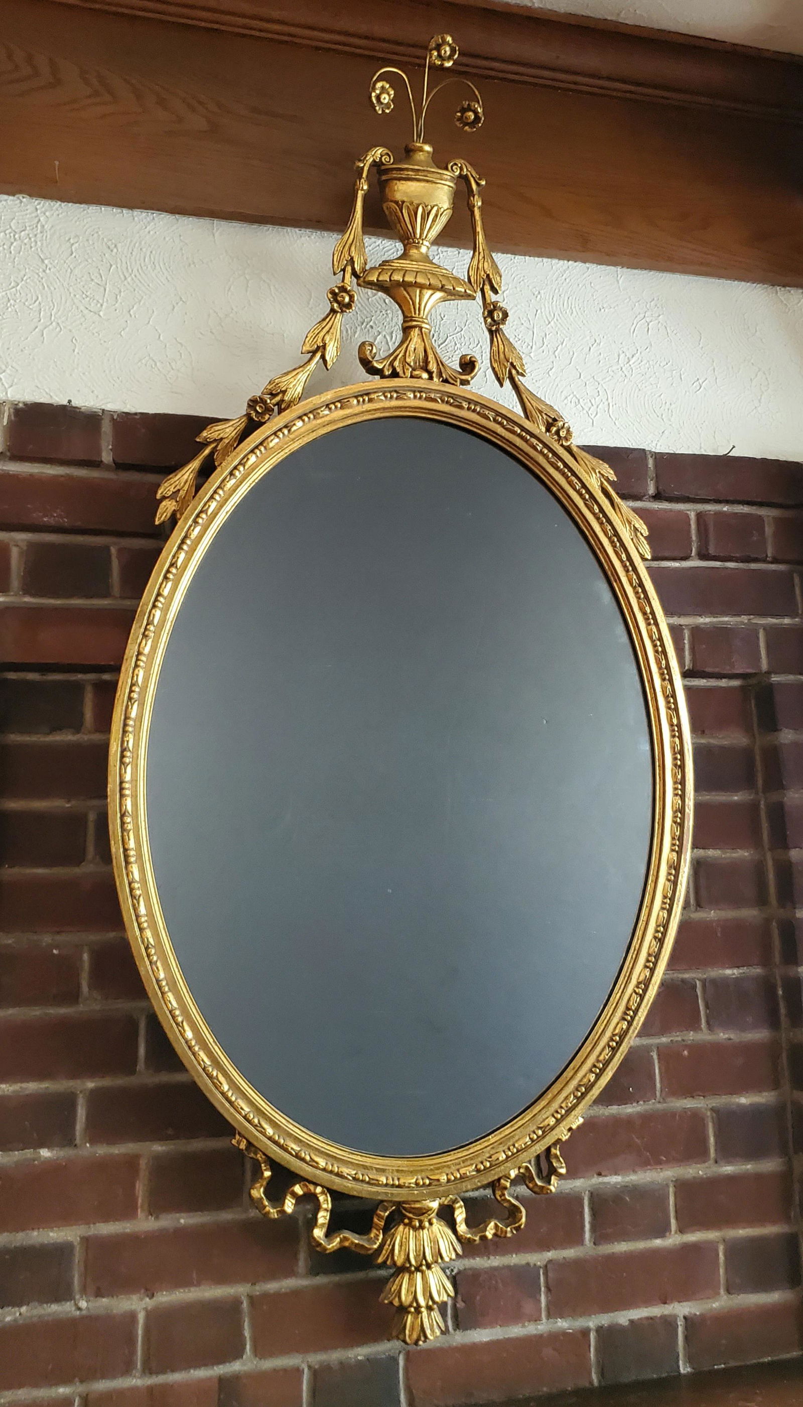 Oval Gilt Mirror with Crest: 24" wide X 50" high. IMPORTANT: Before bidding, please read the terms and conditions below. When you registered for the auction you agreed to these terms and will be required to comply with them.
