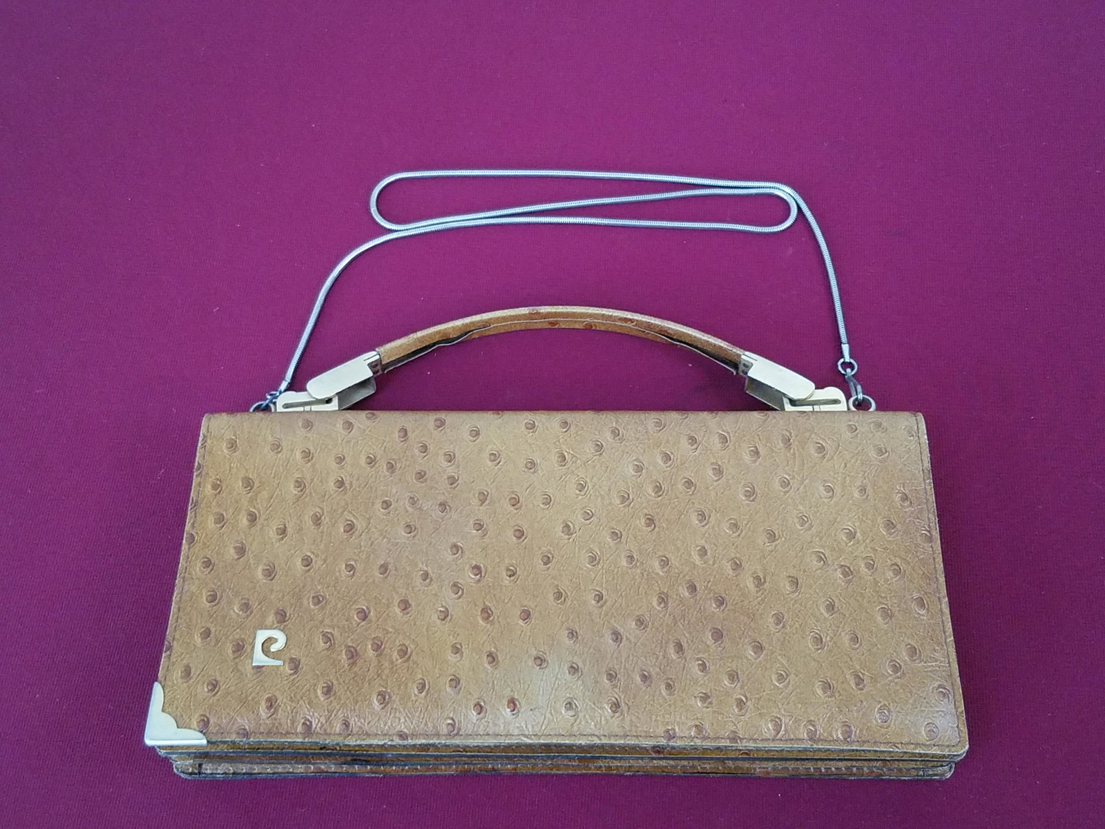 Ostrich Skin Pierre Cardin Clutch Hand Bag: 12" wide x 6" high. Handle with adhesive loss. IMPORTANT: Before bidding, please read the terms and conditions below. When you registered for the auction you agreed to these terms and will be required