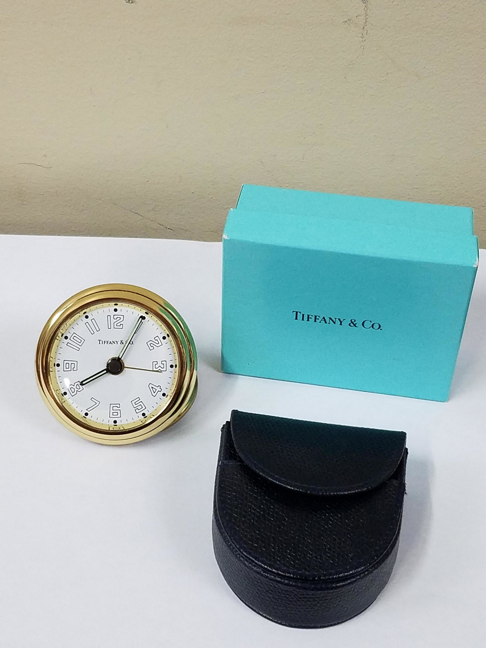 Tiffany & Co Travel Alarm Clock: 2-1/2" diameter x Adjustable height. Needs new battery. Original box and case included. IMPORTANT: Before bidding, please read the terms and conditions below. When you registered for the auction you a