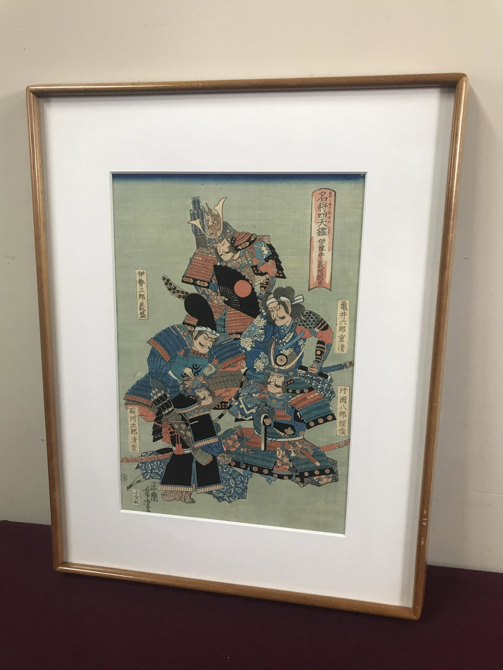 Ukiyo-e School Woodblock Print: Depicts Yoshitsune Minamota, and his retainers. Utagawa Yoshika (1850-1880). Yoshitsune Minamota was a great shogun who riled Japan in the 15th century. Overall with frame 21" high x 16-1/2" wide. IMP