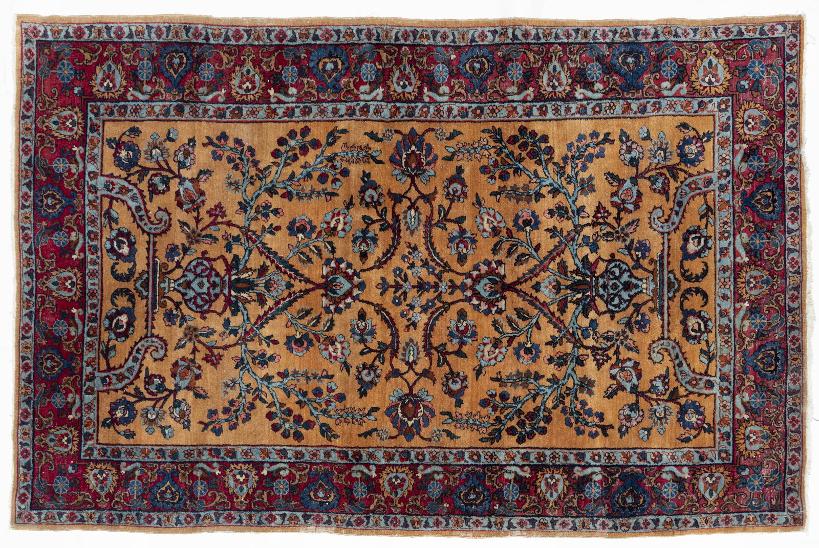 Persian Sarouk Room Size Rug: DESCRIPTION: Persian Sarouk area rug. Iran, 1940's. Tan ground with blue floral and scrolling design and red border. Faded label to back corner. MEASUREMENTS: 6' 11-1/2" x 4' 6". CONDITION: Losses to 