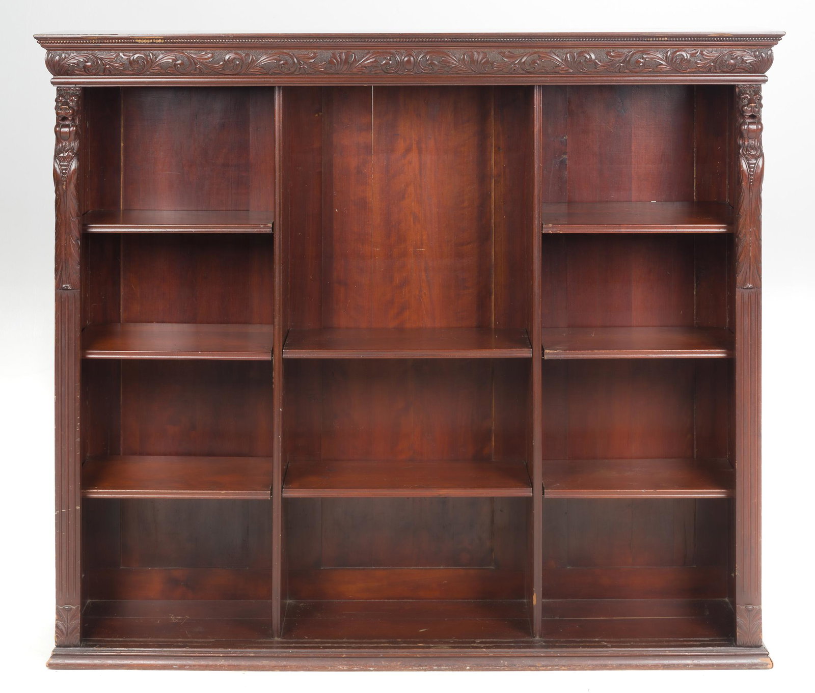 Victorian Renaissance Revival Bookshelf: DESCRIPTION: Victorian Renaissance Revival mahogany bookshelf top circa 1880-90. Adjustable shelves within a rectangular case surmounted by a carved frieze and flanking lions. The reverse with a fragm