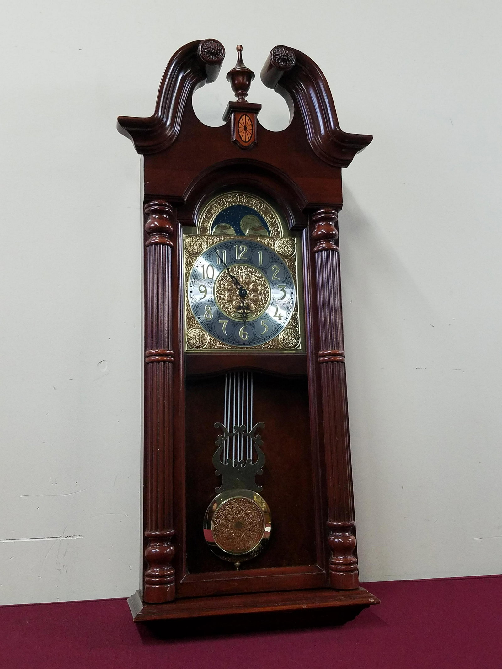 Howard Miller Wall Clock: Battery operated. 16-1/4" wide x 6-1/2" deep x 36-1/4" high. IMPORTANT: Before bidding, please read the terms and conditions below. When you registered for the auction you agreed to these terms and wi