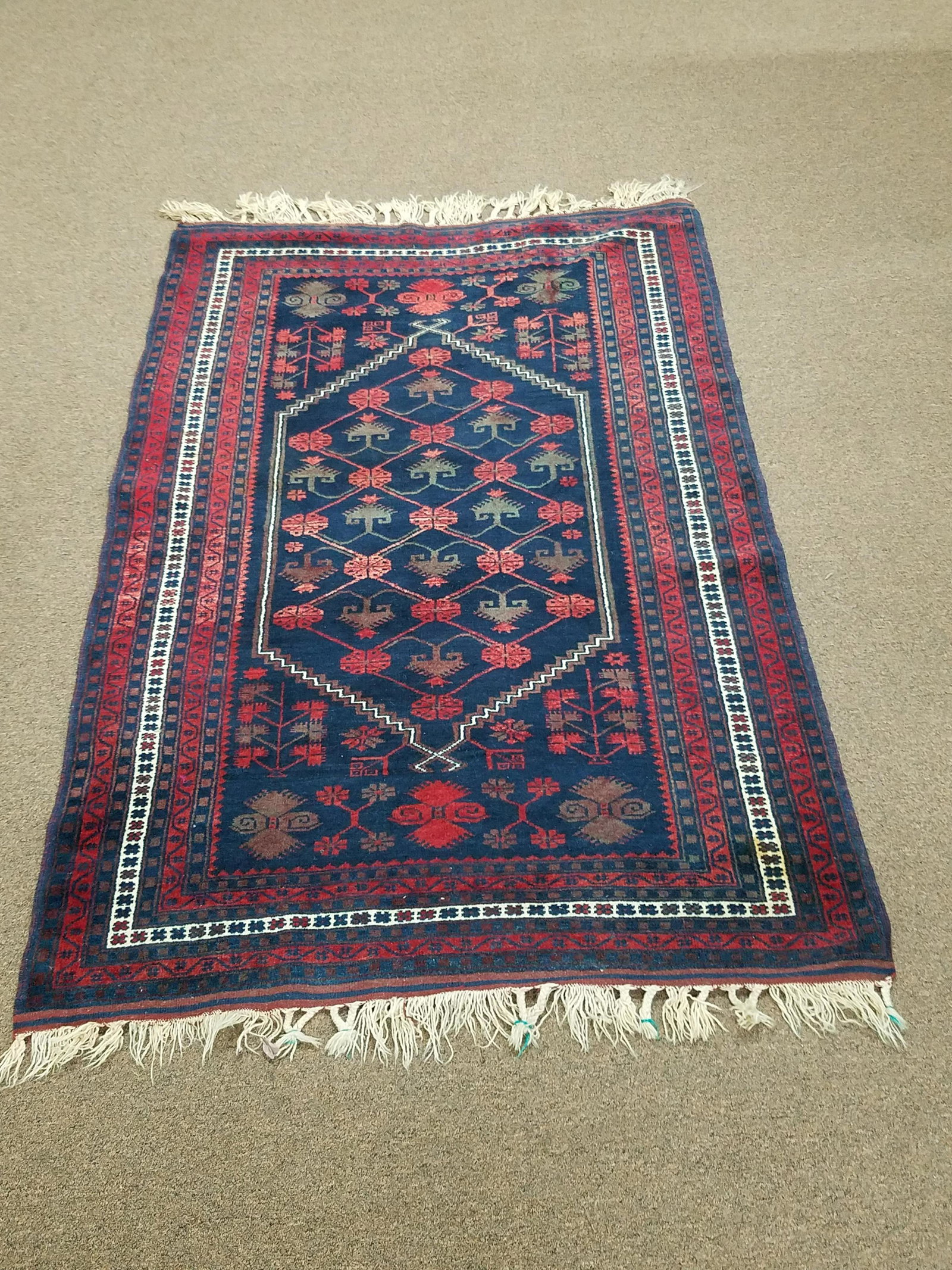 Area Rug: Hand woven. 6'3" long x 3'10" wide. Minor staining. IMPORTANT: Before bidding, please read the terms and conditions below. When you registered for the auction you agreed to these terms and will be req