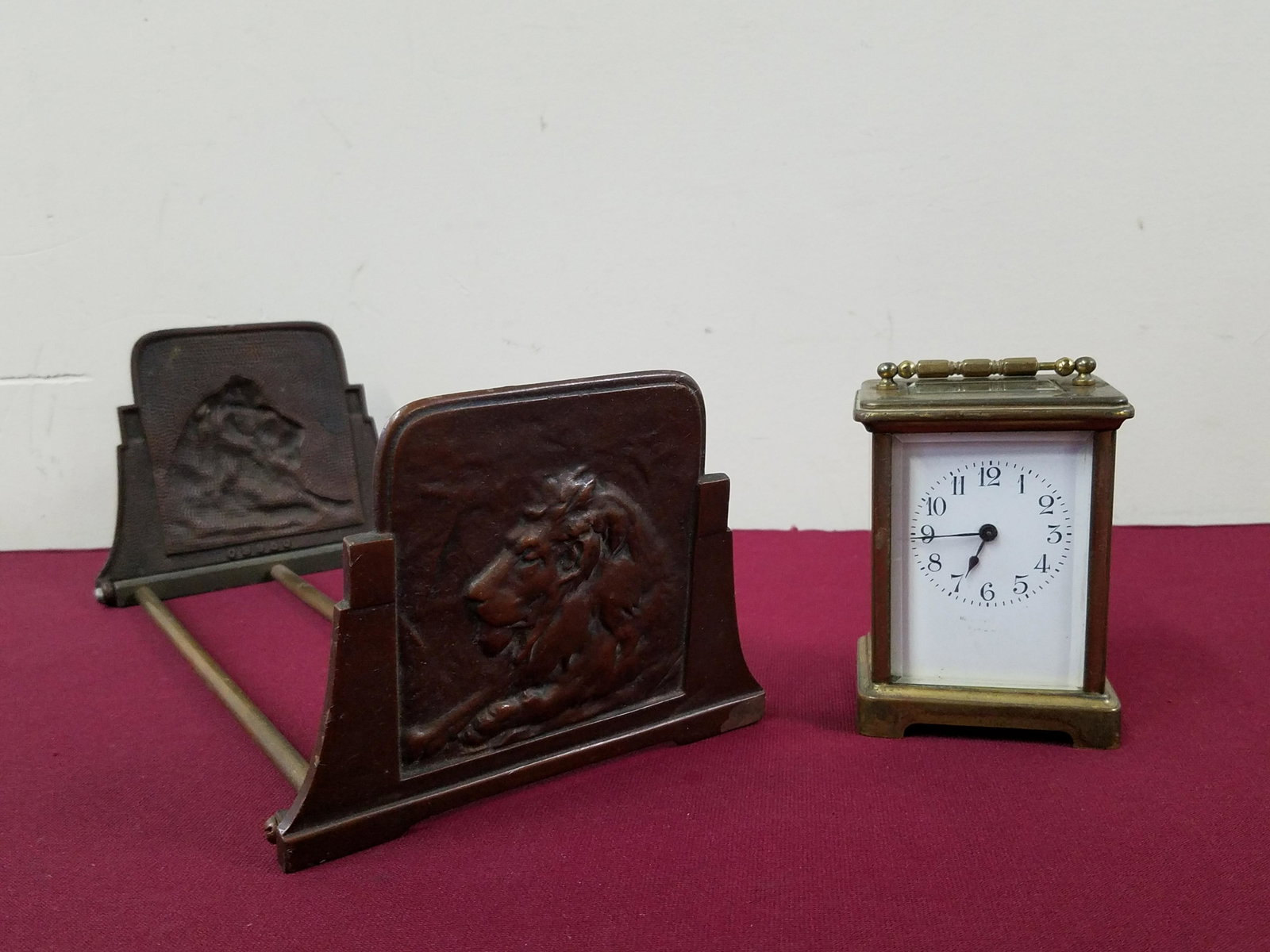 Carriage Clock and Lion Book Holder: Carriage clock: Starts and stops. Made in France. Face with some wear. 4-1/2" high. Book holder: Marked: 09950. Collapsible. 13-1/2" to 24" long. IMPORTANT: Before bidding, please read the terms and c