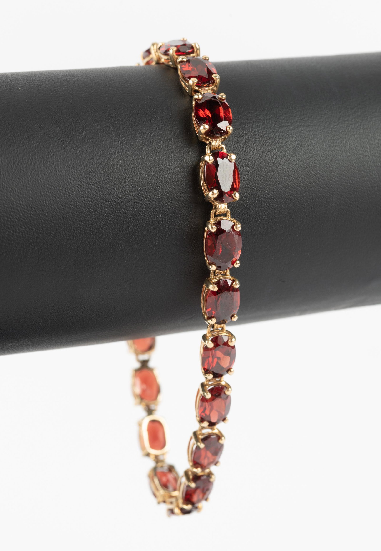 10K and Garnet Bracelet: 6-1/2" long. 5.0 dwt. IMPORTANT: Before bidding, please read the terms and conditions below. When you registered for the auction you agreed to these terms and will be required to comply with them.