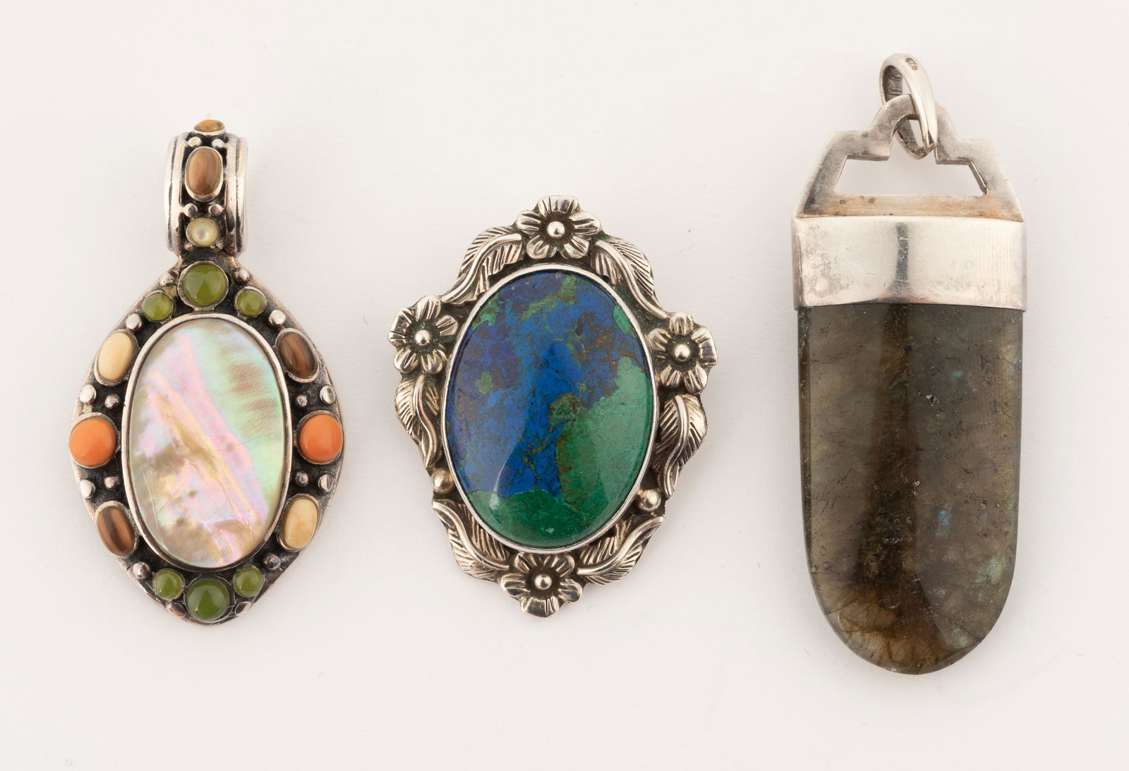 3 Sterling and Hardstone Pendants: Mother of pearl pendant 1-2/3" x 1". Lapis and malachite pendant brooch 1-1/2" x 1-1/4". IMPORTANT: Before bidding, please read the terms and conditions below. When you registered for the auction you