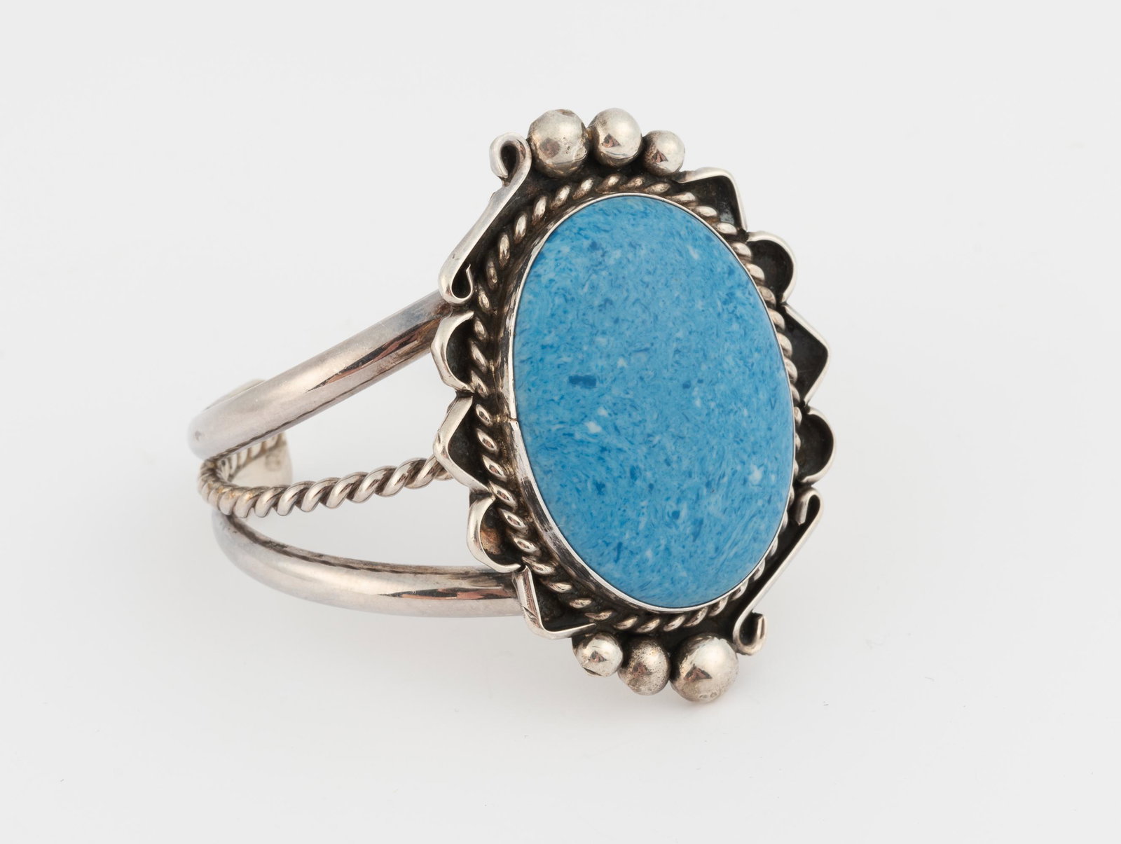 Willie Saiz Navajo Sterling and Blue Stone Cuff: 2-1/3" at widest point. Interior of cuff 2" at widest point. IMPORTANT: Before bidding, please read the terms and conditions below. When you registered for the auction you agreed to these terms and wi