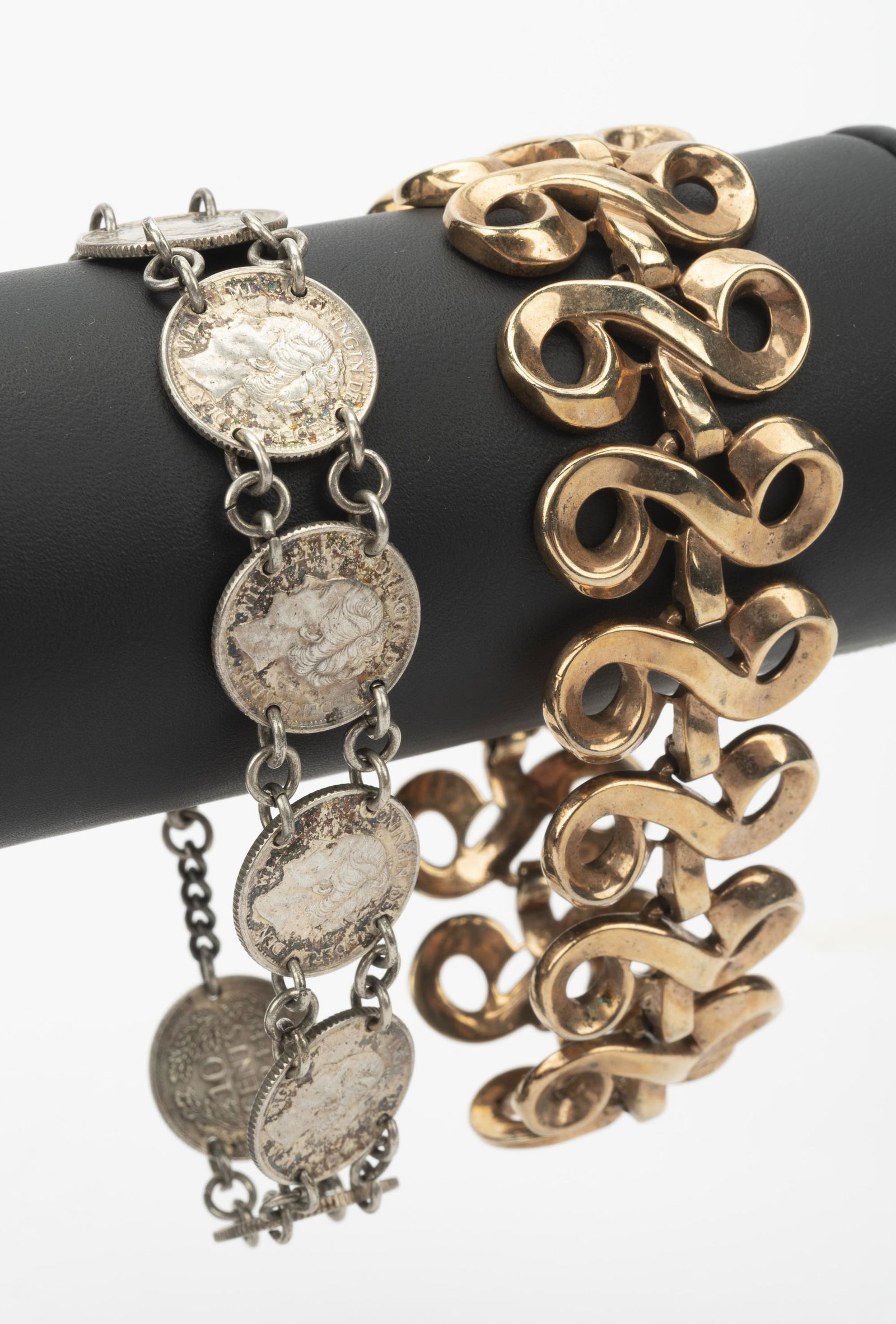 2 Link Bracelets Incl Coin: Gold-filled Trifari bracelet 7-1/4" long. 10 cent Wilhelmina 9 coin bracelet 7" long. IMPORTANT: Before bidding, please read the terms and conditions below. When you registered for the auction you agr