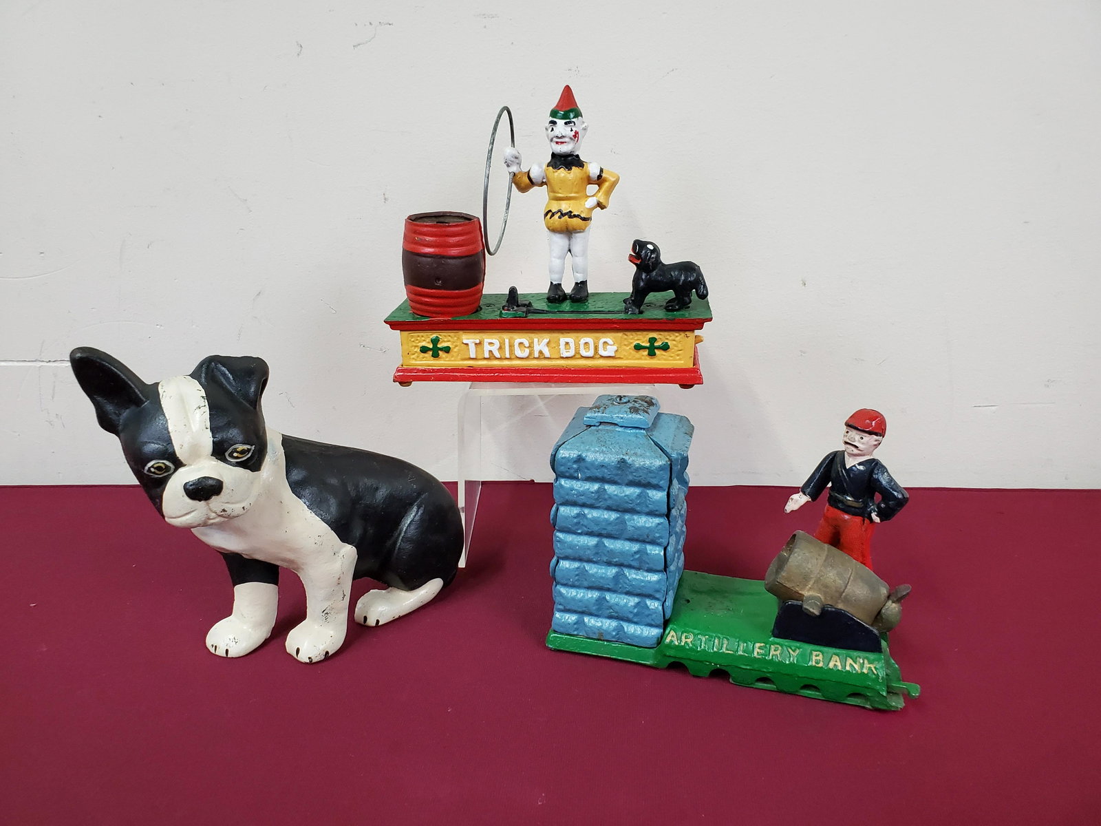 2 Cast Iron Banks & Dog Door Stop: Trick dog bank 8" wide X 2 1/2" deep X 7" high. Door stop 9" wide X 4" deep X 7 1/2" high. IMPORTANT: Before bidding, please read the terms and conditions below. When you registered for the auction yo