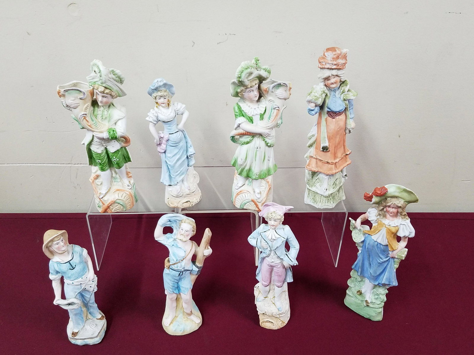 10 Bisque Figurines: 7" to 18" high. Unmarked. One woman figure with repair at neck. One man with repaired base. Repair to one of the gentleman's hands. IMPORTANT: Before bidding, please read the terms and conditions belo