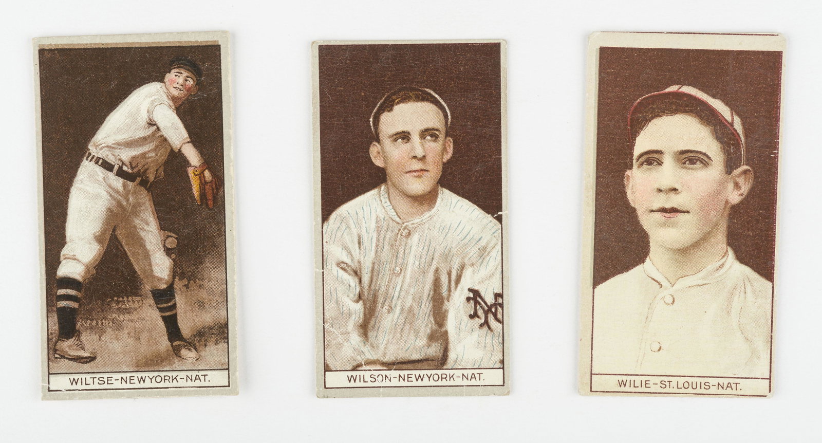 T207 1912 Wiltse, Wilson, & Wilie: Brown background. Good-VG IMPORTANT: Before bidding, please read the terms and conditions below. When you registered for the auction you agreed to these terms and will be required to comply with them.