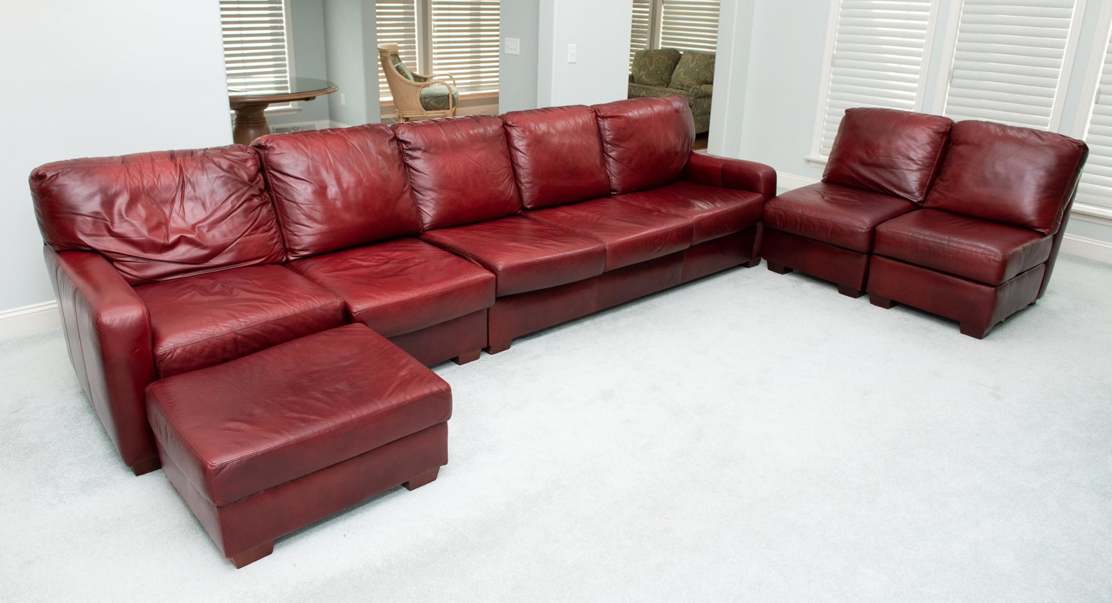Distinction Leather Sectional with Ottoman: 137” long to 49” long x 35” deep x 35” high. IMPORTANT: Before bidding, please read the terms and conditions below. When you registered for the auction you agreed to these terms and will be re