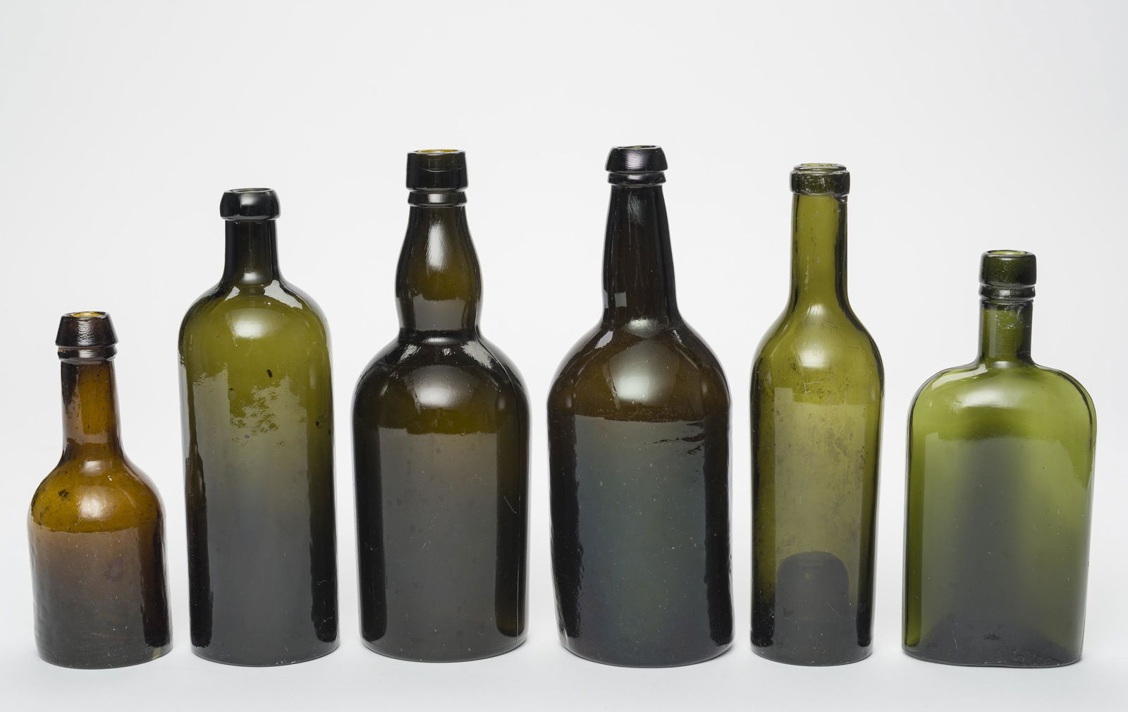 6 Antique Bottles and Flasks: 6-3/4" high to 9-1/2" high. IMPORTANT: Before bidding, please read the terms and conditions below. When you registered for the auction you agreed to these terms and will be required to comply with the