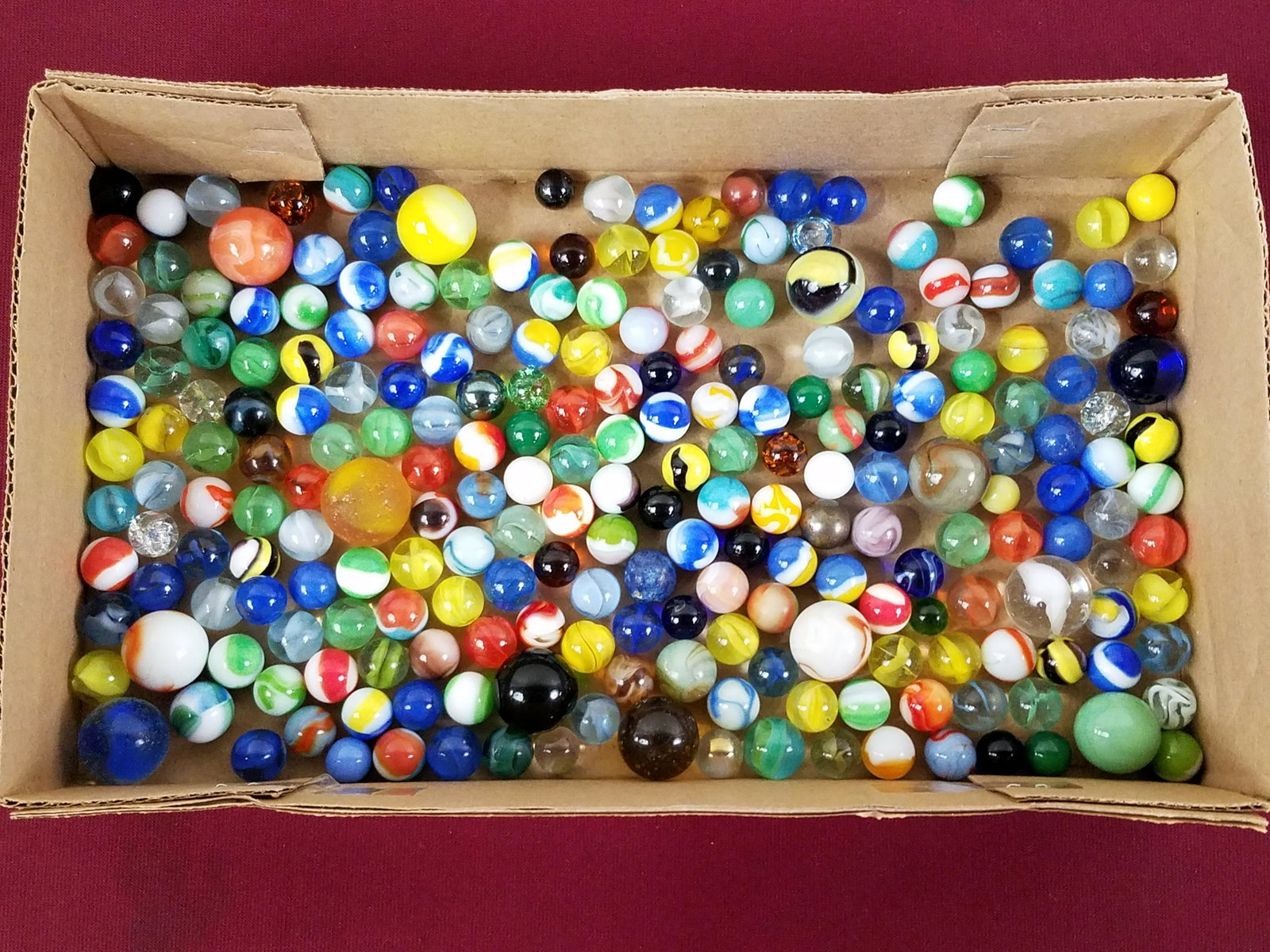 229 Glass Marbles: Various sizes. IMPORTANT: Before bidding, please read the terms and conditions below. When you registered for the auction you agreed to these terms and will be required to comply with them.