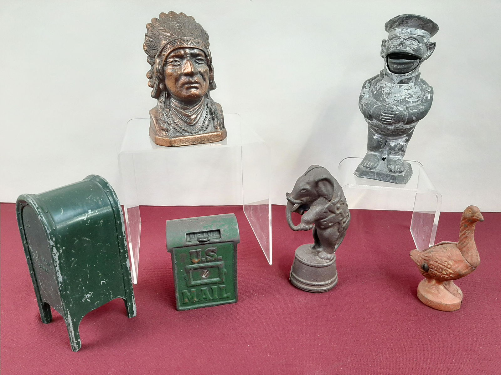 4 Cast Iron and 2 Cast Metal Banks: Includes Red Goose Shoes and U.S. Mail. 3 1/2" to 6 3/4" high. All banks sold as is. IMPORTANT: Before bidding, please read the terms and conditions below. When you registered for the auction you agre