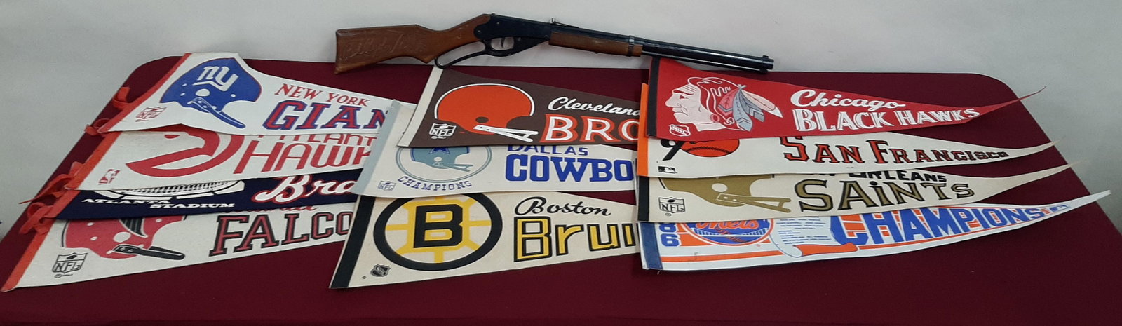 Red Ryder BB Gun and 11 Sports Pennants: Pennants each 30" wide X 12" high. IMPORTANT: Before bidding, please read the terms and conditions below. When you registered for the auction you agreed to these terms and will be required to comply w