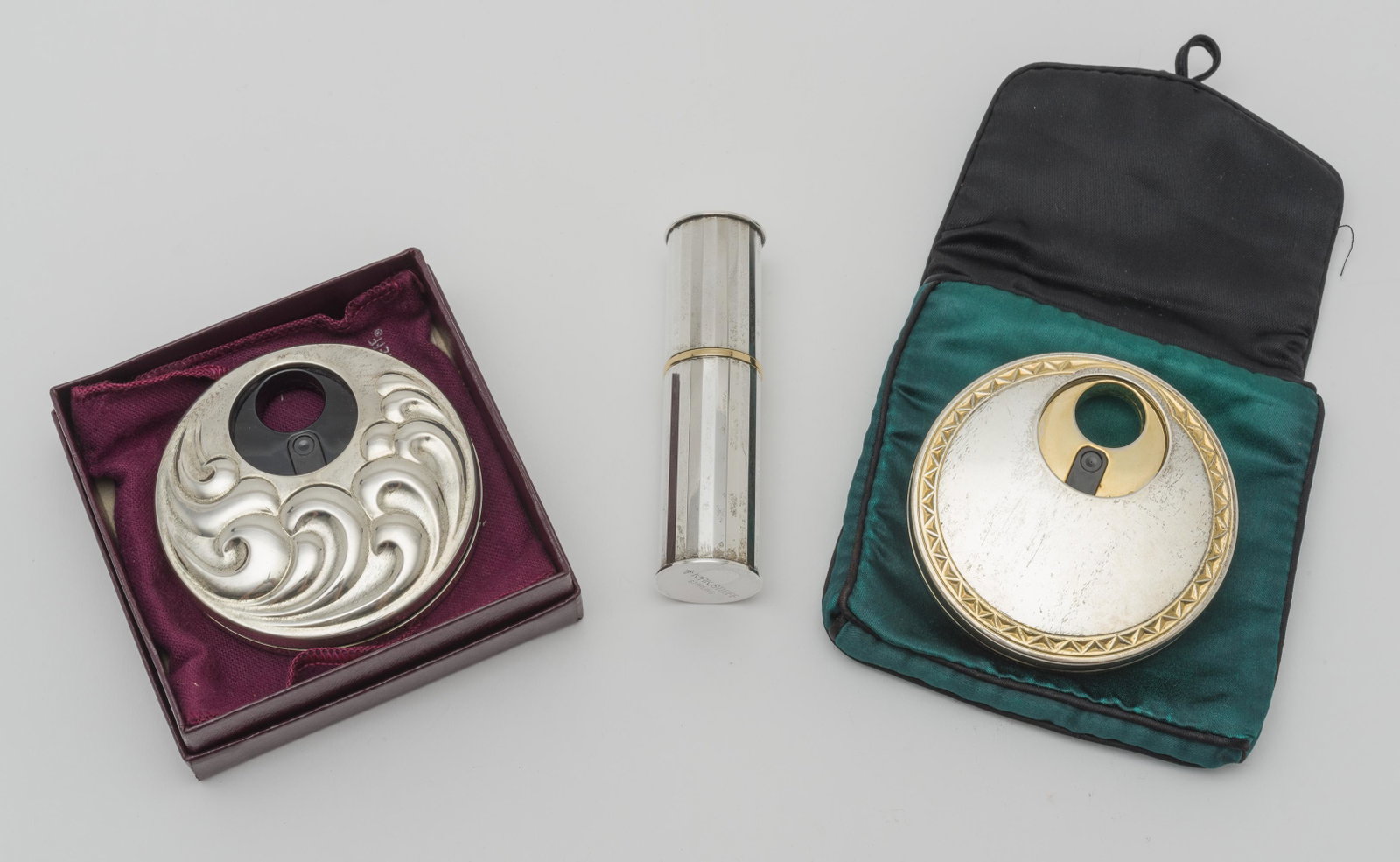 3 Kirk Steiff Perfume Atomizers: One in original box. One with original pouch. Round atomizers 2-3/4" diameter. Cylinder 3-1/2" high. 6.6 troy ounces total including parts.