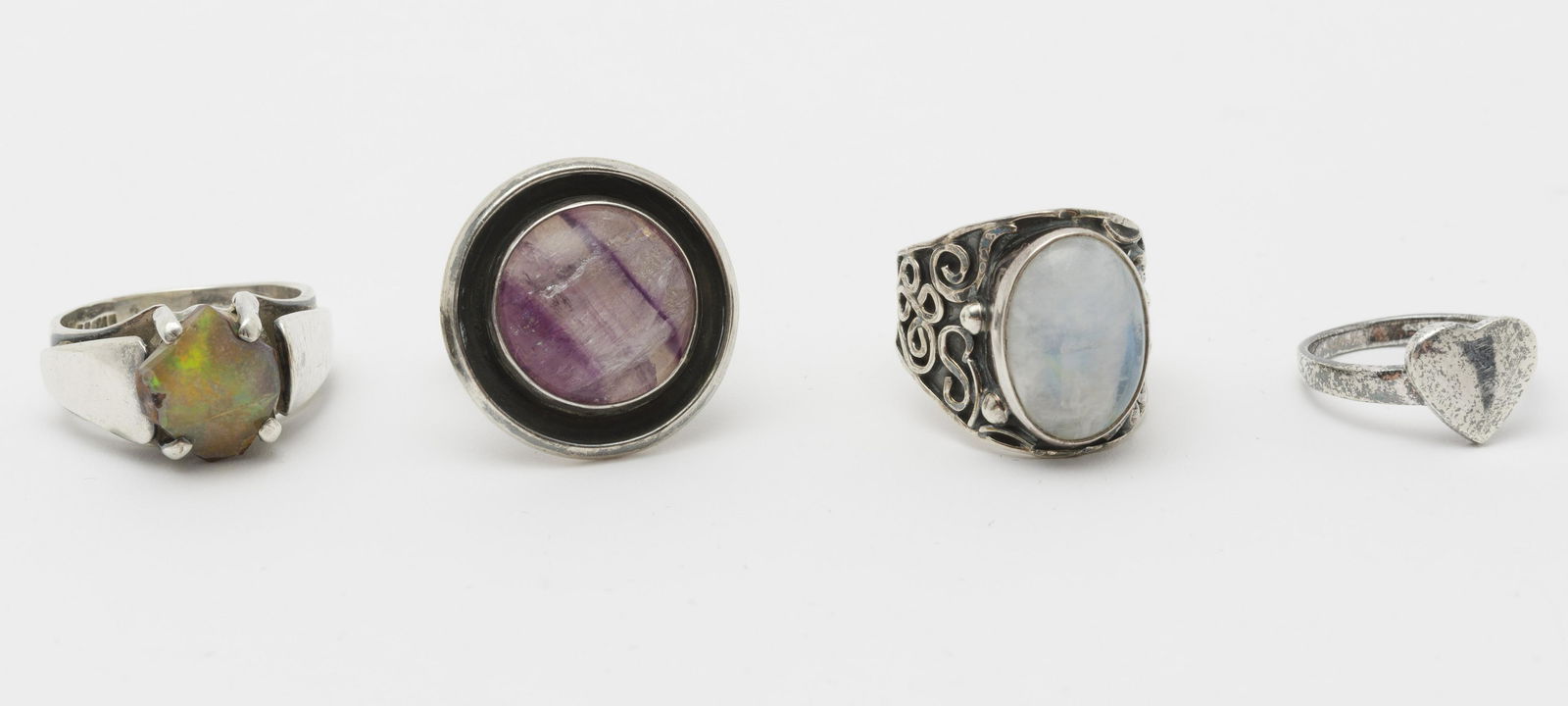 4 Sterling Rings Incl Opal and Moonstone: Ring sizes 7-3/4 through 11. Heart ring top measures 1" across; Amethyst ring top 1" diameter.