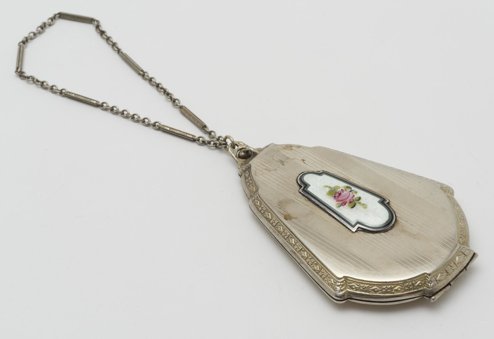 Marathon Enamel Decorated Silverplate Compact: 3-5/8" long x 2-5/16" wide, chain 8" long.