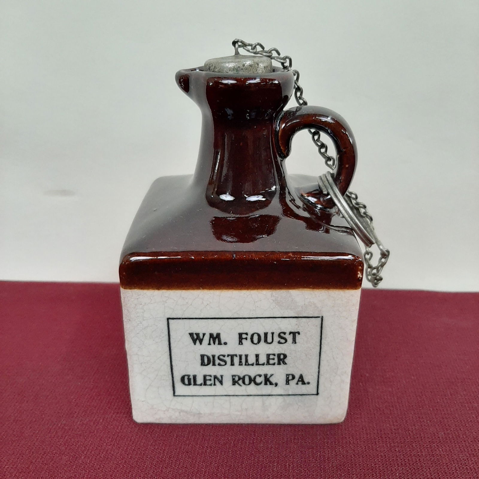 4 1/2" William Foust Disteller Advertising Bottle: 2 3/4" wide X 2 3/4" deep X 4 1/2" high. IMPORTANT: Before bidding, please read the terms and conditions below. When you registered for the auction you agreed to these terms and will be required to co
