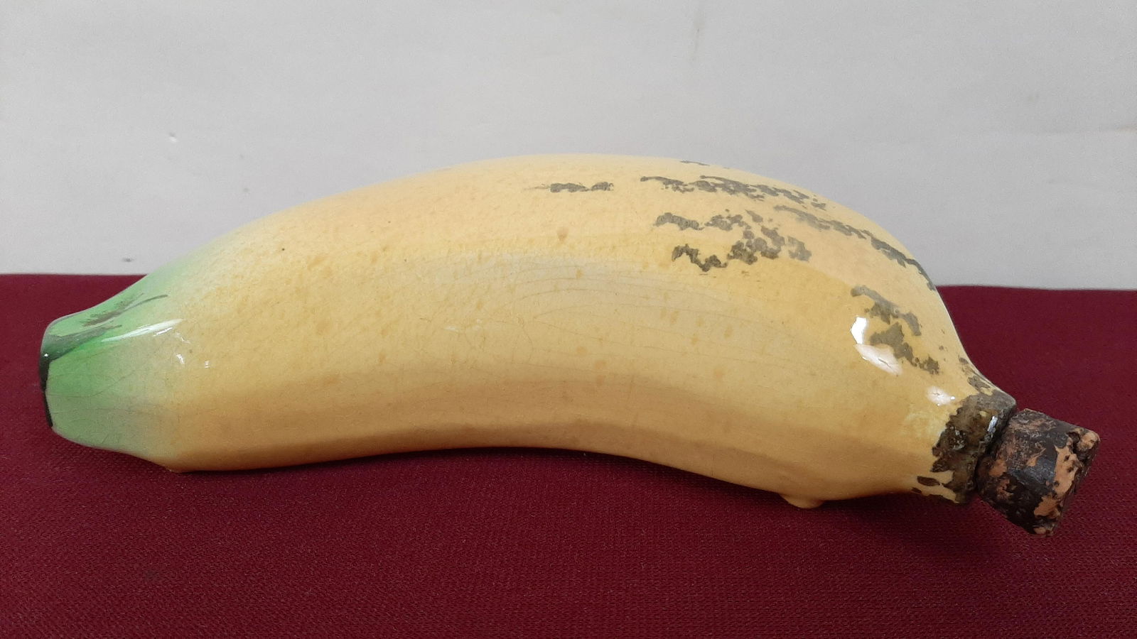 William Foust Distiller Banana Flask and Labels: Includes 6 paper Foust labels. 7 1/2" long. IMPORTANT: Before bidding, please read the terms and conditions below. When you registered for the auction you agreed to these terms and will be required to