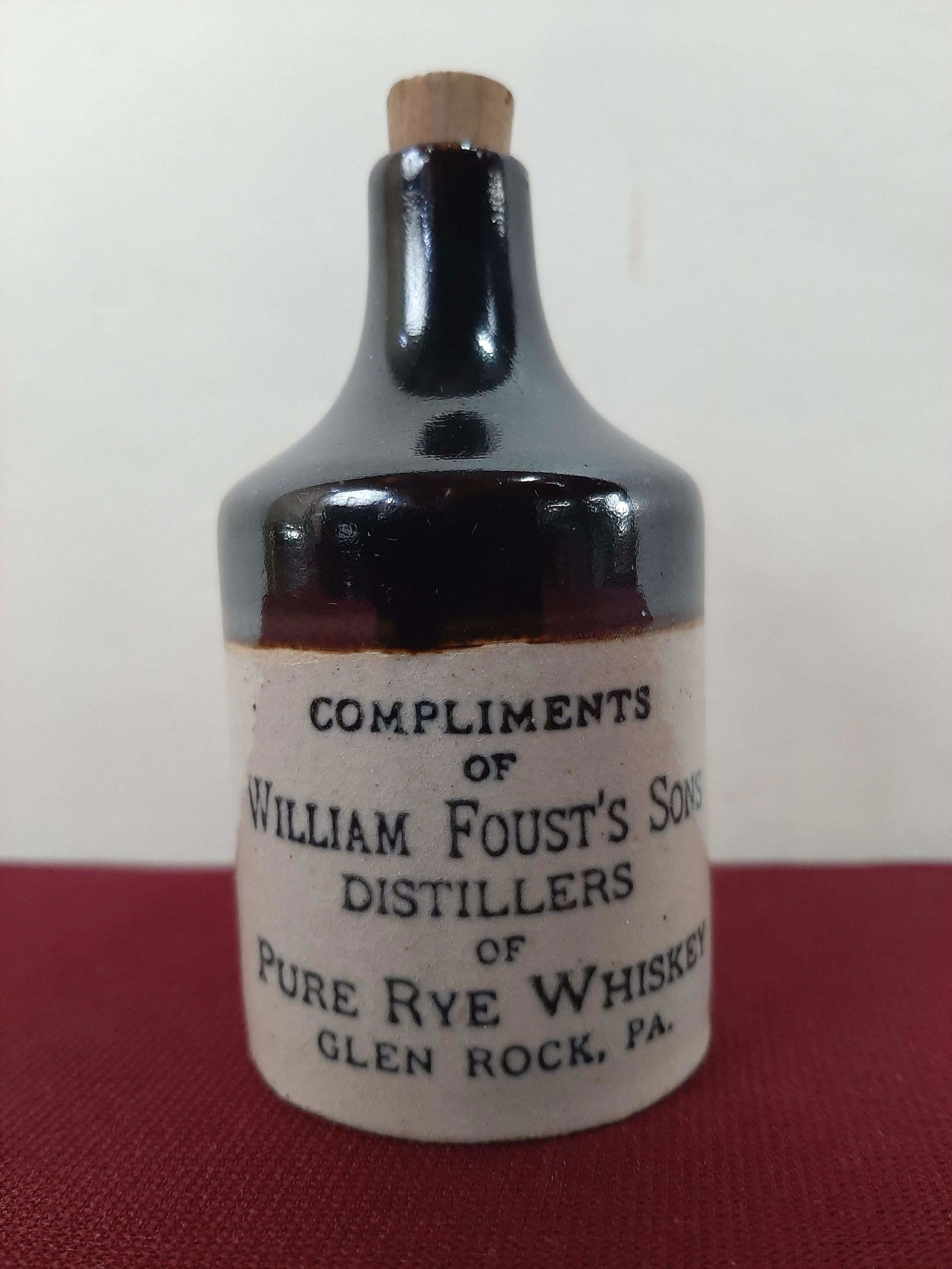 3 1/2" William Foust Distillers Advertising Bottle: 1 3/4" diameter X 3 1/2" high. IMPORTANT: Before bidding, please read the terms and conditions below. When you registered for the auction you agreed to these terms and will be required to comply with