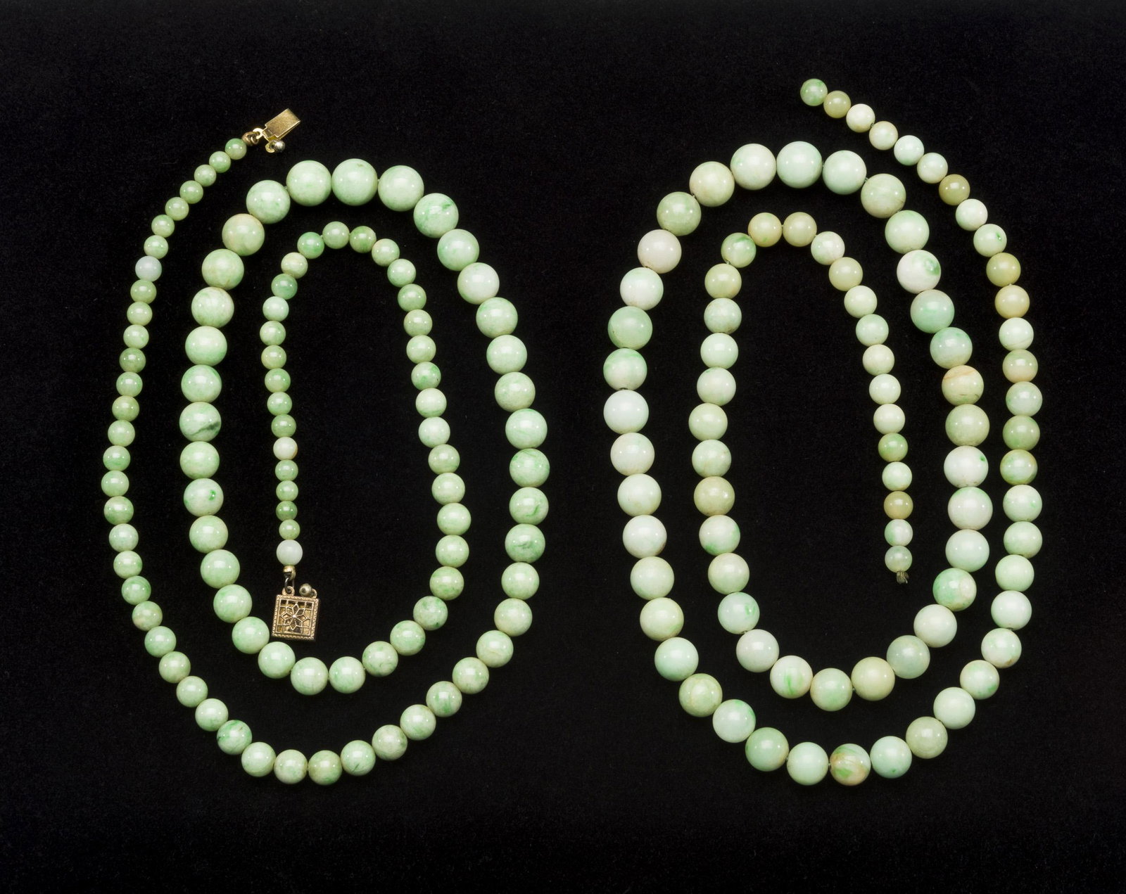 2 Strands of Jadeite Beads: DESCRIPTION: Two strands of jadeite beads. One strand of 88 beads ranging in size from 5mm to 10 mm. One strand with gold plated clasp with 101 beads ranging in size from 4mm to 10 mm. MEASUREMENTS: S