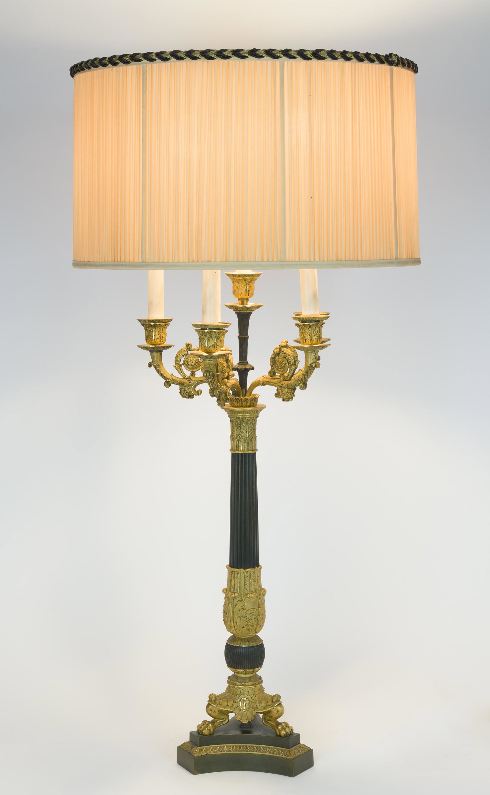 Bronze Dore Candelabra Mounted as Lamp: DESCRIPTON: Bronze dore candelabra, with six candle holders, mounted as a lamp. Bronze fluted column with dore acanthus decoration and scroll arms. Working condition. MEASUREMENTS: 7" wide x 7" deep x