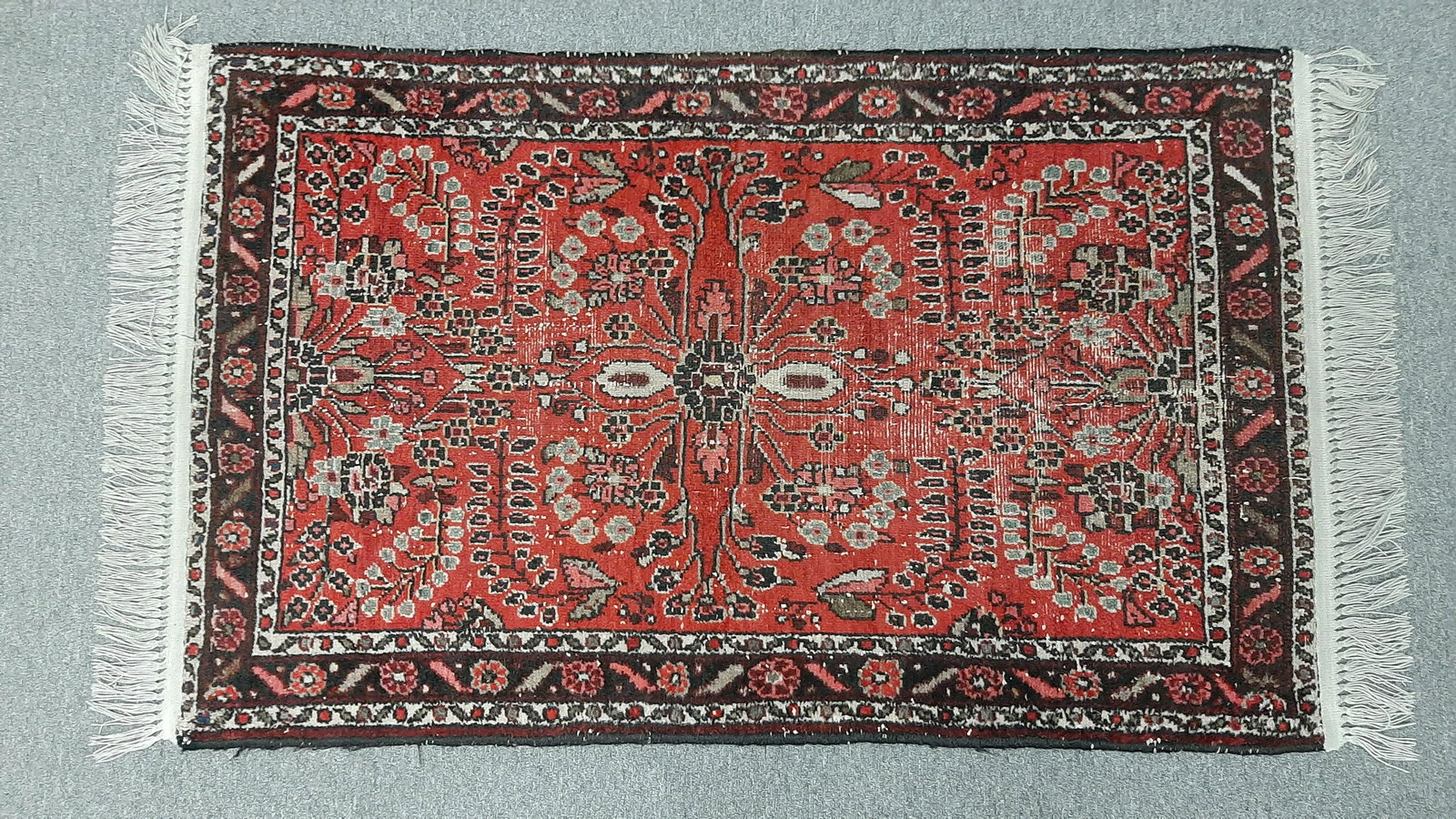 Persian Dergazine Area Rug: Hand woven. Red field with brown and cream highlights. Made in Iran in the first half of the 20th century. 4' 8" long x 2' 6 1/2" wide. IMPORTANT: Before bidding, please read the terms and conditions 