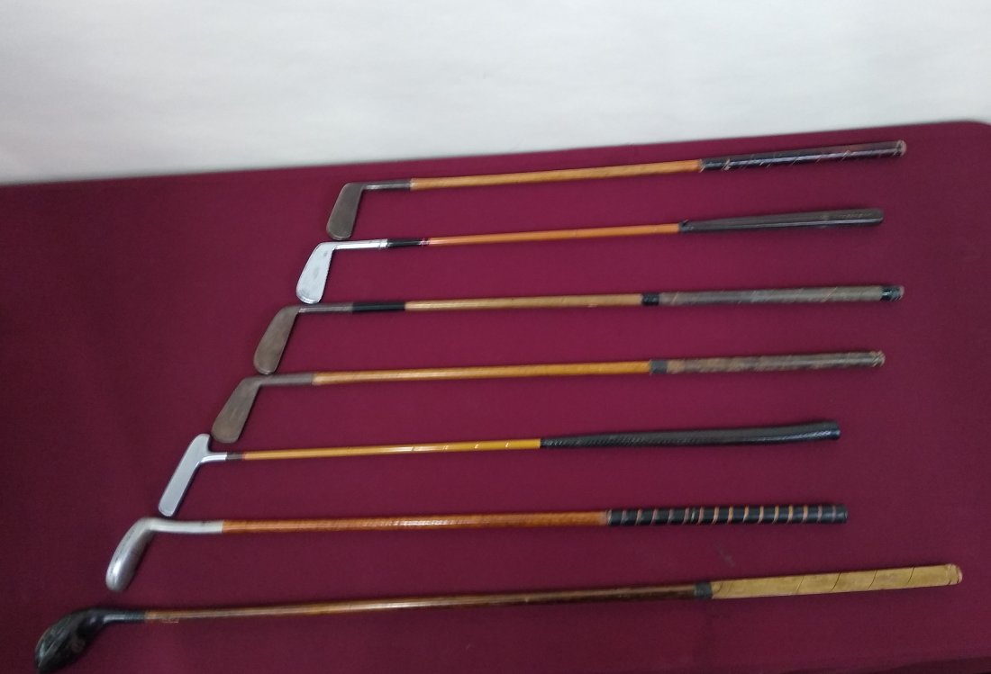7 Vintage and Antique Golf Clubs: Including John Lurie, Peacock, H&B, and 3 covers. 34" long to 42-1/2" long. IMPORTANT: Before bidding, please read the terms and conditions below. When you registered for the auction you agreed to the