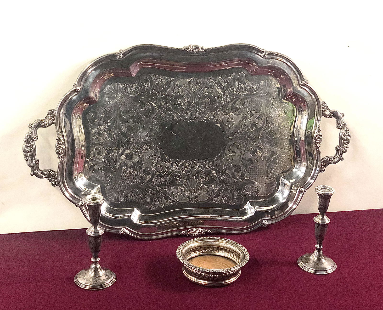 4 Pcs Silver & Silverplate: Pair of Empire weighted candle holders, Sterling wine coaster, and silverplate tray. IMPORTANT: Before bidding, please read the terms and conditions below. When you registered for the auction you agre