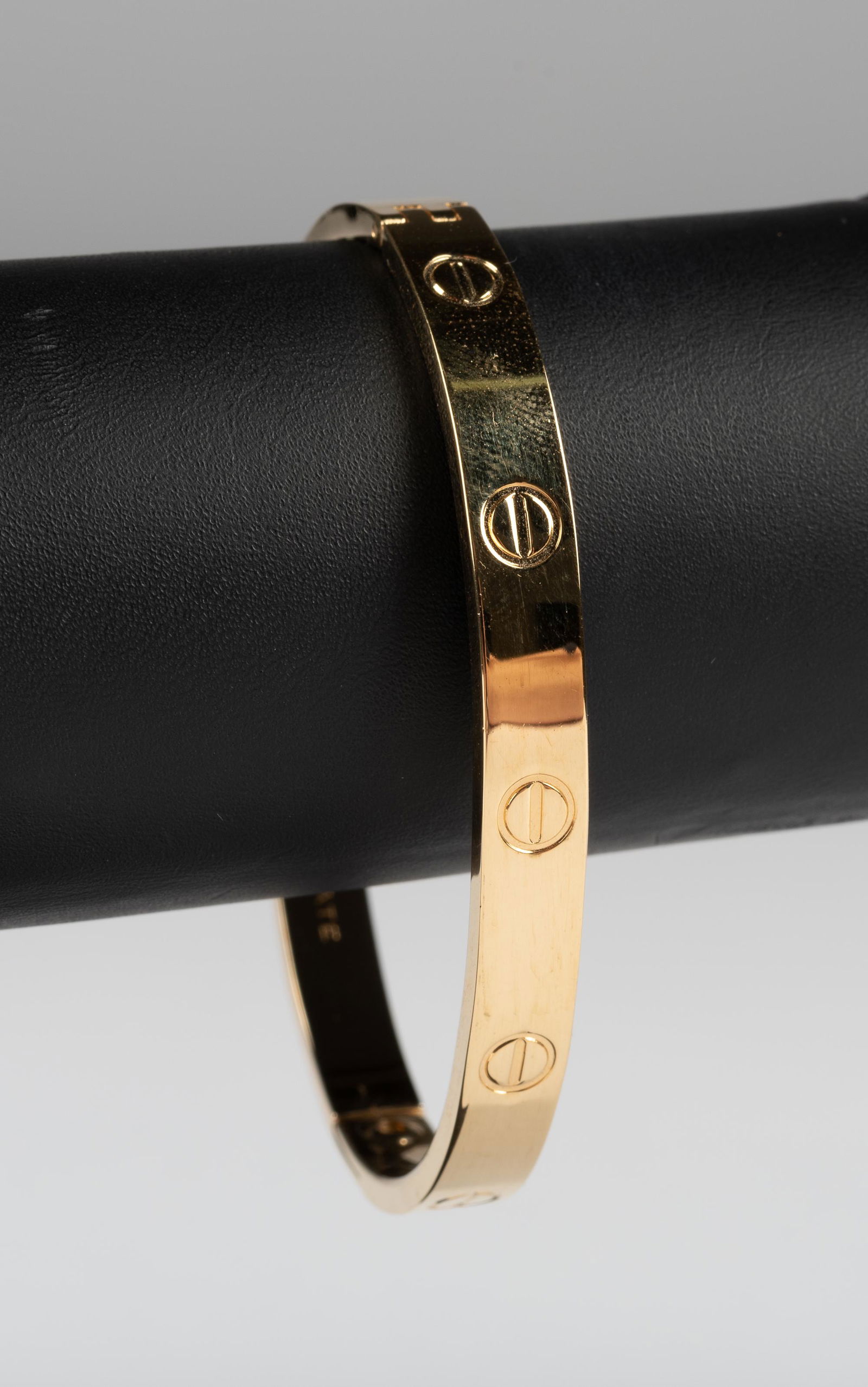 Reproduction Cartier Love Bracelet: Gold plated bangle. Marked "1970 Aldo Cipullo Gold Electroplate" and "Charles Revson, Inc.". Interior 2-1/2" x 2". IMPORTANT: Before bidding, please read the terms and conditions below. When you regis