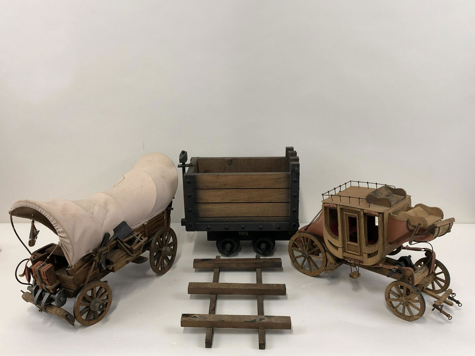 3 Wood Western Vehicles: Includes mine cart with track, Conestoga wagon, and stage coach. 13 1/4" x 20" long, 11 1/2" x 13" high.