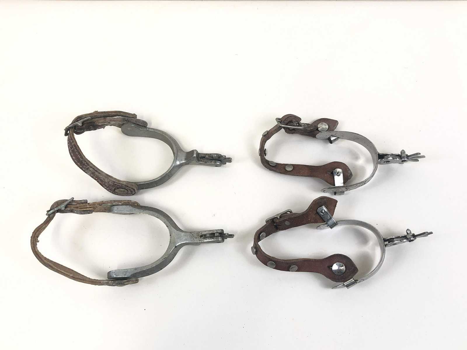 2 Pairs of Mid Century Spurs: Adjustable back straps.