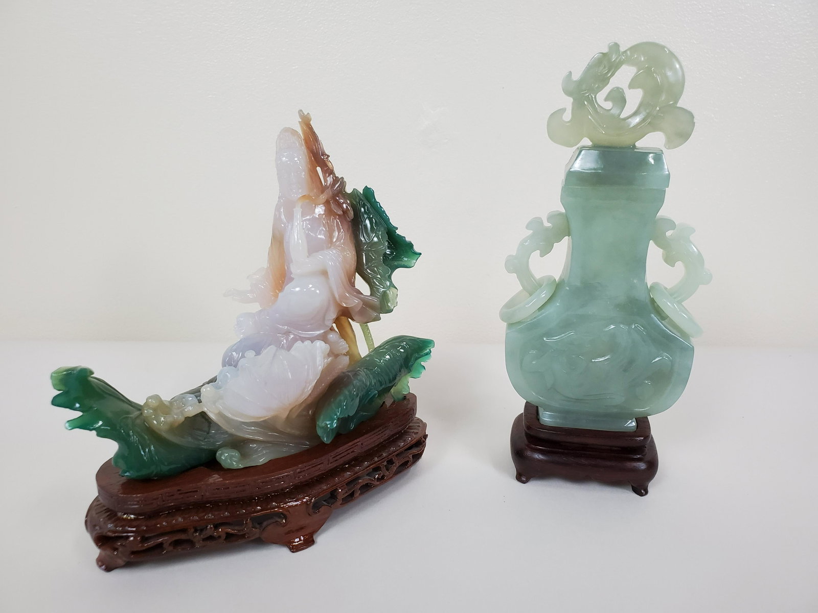 Jade Urn & Quan Yin Figure: Includes jade urn with base and Quan Yin green and lavender jade figure. Urn 3" wide X 1 1/2" deep X 7" high. Figure has small damage to right hand. 5 1/2" wide X 3" deep X 6" high.Quan Yin hand detac