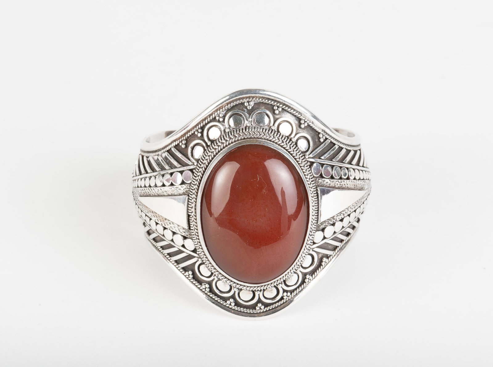 Sterling Carnelian Cuff Bracelet: Interior 2" x 2-1/4". Top 2-1/2" wide. 2.6. ozt. IMPORTANT: Before bidding, please read the terms and conditions below. When you registered for the auction you agreed to these terms and will be requir