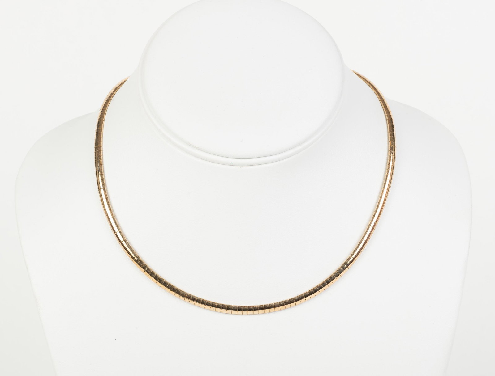 10k Gold Omega Necklace: 16-1/4" long. 4mm wide. 12 dwt. IMPORTANT: Before bidding, please read the terms and conditions below. When you registered for the auction you agreed to these terms and will be required to comply with